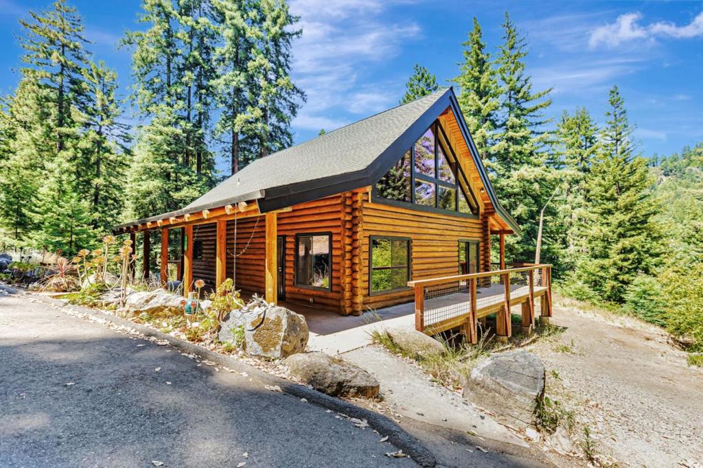 Discover the perfect blend of rustic charm and modern comfort with this rare opportunity to own two distinct homes on over 3.3 sunny, usable, private acres in the beautiful SC Mountains. Just a short walk to the iconic Brookdale Lodge and minutes to SC and the Bay Area, this is mountain living at its finest. The custom log home is a true showpiece, featuring soaring open-beam ceilings, expansive windows, and wood finishes throughout. Natural light floods the spacious living and dining areas, while the immaculate kitchen, 2 beds and 2 full baths offer space for comfortable living. Bonus room. Step outside onto the large, mostly covered wraparound porch, ideal for morning coffee, evening sunsets, or simply soaking in views of the redwood ridge line and surrounding nature. Tucked away for optimal privacy is the original vintage cabin, showcasing timeless craftsmanship with old-growth redwood, original hardwood floors, and a dramatic floor to ceiling stone hearth. With three bedrooms, two baths, and an open kitchen with bar seating flowing into the vaulted living and dining areas, this home radiates warmth and nostalgic character. Each home enjoys excellent separation and privacy, perfect for multi-generational living, guest accommodations, rental income, or a personal retreat.