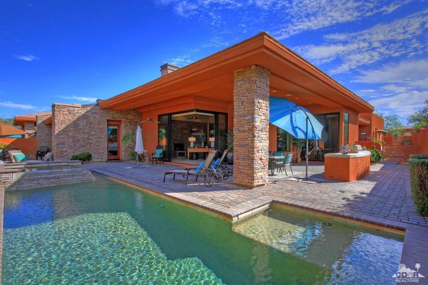 Palmilla, not just a home a lifestyle! This master planned community features boldly designed showcase homes set among shimmering lakes, original metal sculptures and lush desert landscaping that has won several builder awards! The WEST facing highly sought after Palo Brea model features a terrific open floor plan with ceiling to floor pocket sliders, living rm stack stone wall to wall fireplace, 24x24 tiled flooring, vaulted ceilings, step down wet bar, granite, designer appointed furnishings, gourmet chef's kitchen, custom paint & electronics throughout the home make it move in ready. Family and friends can enjoy the private backyard with custom pebble tech pool with raised stack stone spa, oversized flag stone BBQ, and upgraded pavers throughout the backyard.