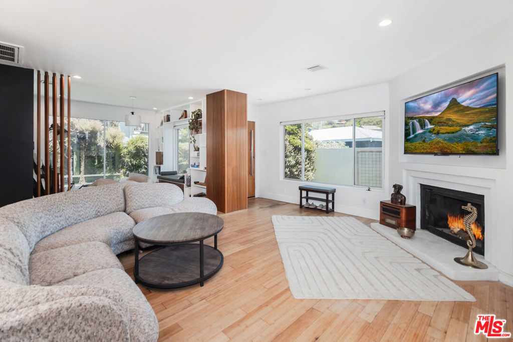 Stylishly updated, character-filled home located in the heart of vibrant and sought-after Eagle Rock! This versatile property offers 3 bedrooms and 2 bathrooms plus a fully permitted attached ADU with its own address (903 Pine Grove), a 1 bedroom + full bath, with plumbing ready for a kitchenette ideal for guests, rental income, or a creative studio space! On the main level, you'll find a bright, open-concept living area flooded with natural light. Enjoy a thoughtfully updated kitchen, beautiful wood floors, recessed lighting, a cozy fireplace, skylight, and flexible spaces including a den and dedicated dining area. Two comfortable bedrooms and a full bath are on the main level, while the expansive lower-level primary suite offers exceptional privacy and a generous en suite bath. Step outside to a spacious, flat backyard and an additional deck area perfect for entertaining, gardening, or simply enjoying the sunshine. Don't miss this opportunity to own a truly special property in one of Eagle Rock's most dynamic neighborhoods. A blend of comfort, creativity, and income potential awaits!