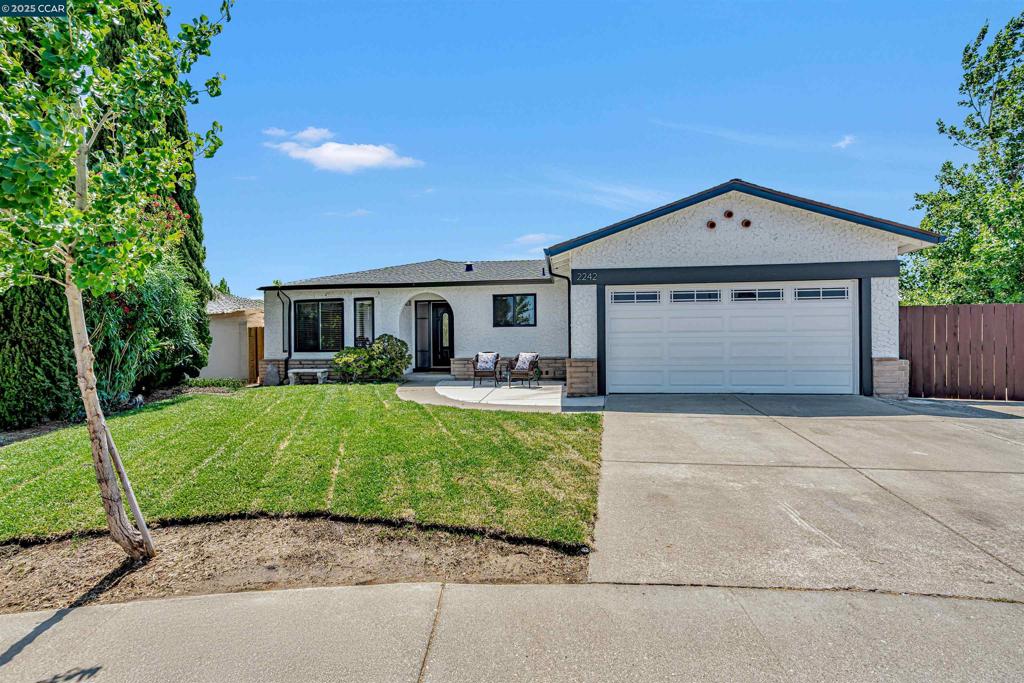 Perfectly positioned at the end of a quiet cul-de-sac, this warm and inviting 4-bedroom, 2-bath home is ideal for family living. With two separate living areas and a large dining room featuring a cozy wood-burning fireplace, there's plenty of space to gather, play, or relax. Enjoy new vinyl flooring, plush new bedroom carpeting, recessed lighting, ceiling fans, and dual-pane windows with treatments for year-round comfort. The eat-in kitchen is family-ready with stainless GE appliances—including a convection oven with air fryer and warming drawer—microwave, dishwasher, Whirlpool fridge with ice maker, and a pull-out pantry. The primary suite includes a barn door entry to an updated ensuite bath. Step outside to a spacious, fenced backyard with stunning hill views—perfect for kids and pets—with RV parking. Additional features include a Nest thermostat, mirrored closet doors, upgraded doors, and a 2-car garage with built-ins and laundry hook-ups. A truly move-in-ready home designed for family life.