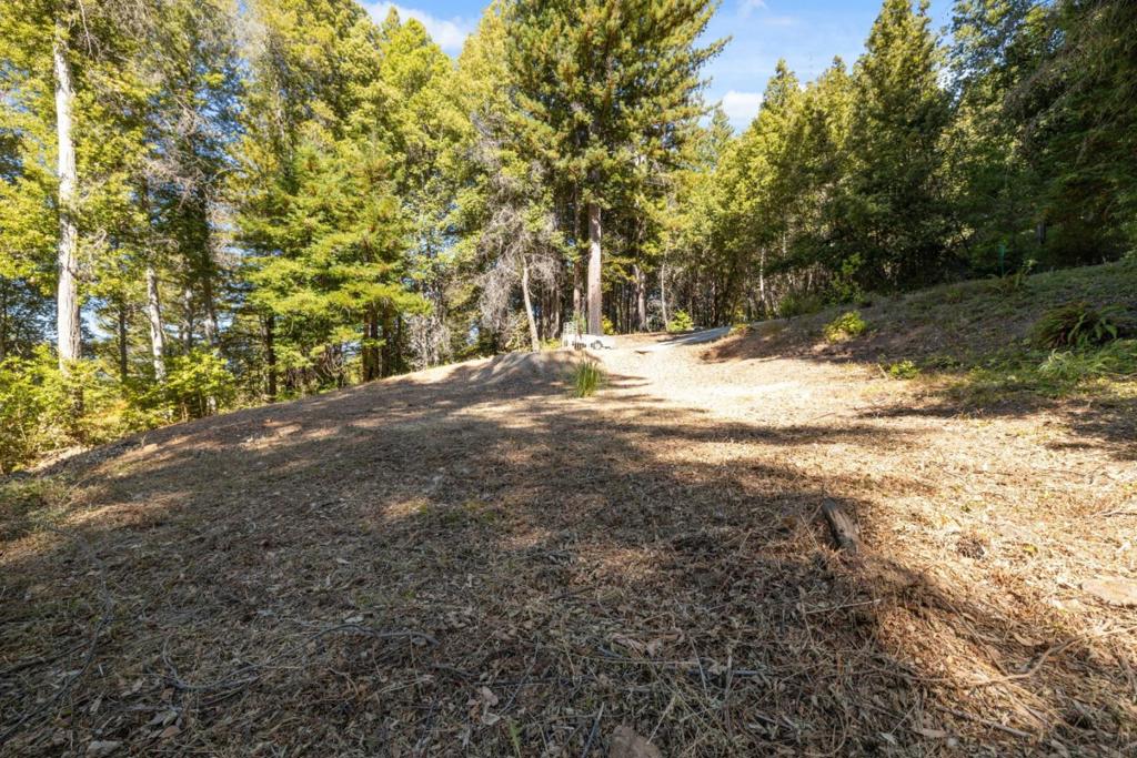 Welcome to 185 Sweetwater Lanea rare 1.29-acre parcel tucked into a peaceful Ben Lomond neighborhood. This blank canvas offers the opportunity to bring your vision to life in the Santa Cruz Mountains. With key infrastructure already in placeincluding an existing septic system with a concrete tank, power at the property line, and access to a shared well (the namesake Sweetwater)youll enjoy a head start on your building plans. Easy paved road access. End of the road privacy. The gently sloping, highly usable land basks in sunshine, making it ideal for gardening, homesteading, or simply soaking up the natural beauty. Expansive mountain views stretch across the valley, adding to the property's unique sense of peace and privacy. There's plenty of space for fruit trees, raised beds, chickens, or your dream home design. Set in a welcoming neighborhood with easy access to town, this location offers the perfect blend of serenity and convenience. Come explore the property and experience the warm air, rustling redwoods, and wide-open potential waiting for you here.