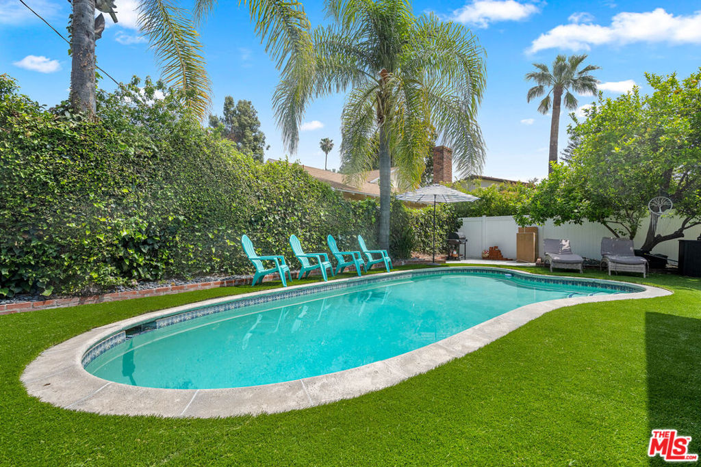 Nestled on a picturesque corner lot in the heart of Valley Village, this stunningly updated mid-century home has been transformed into a modern entertainer's paradise. A perfect blend of timeless charm and contemporary upgrades, this 4-bedroom, 2.5-bathroom residence is a true turnkey treasure.Step inside to discover a bright and inviting interior designed for today's lifestyle. The beautifully updated kitchen features sleek new counters, providing a stylish and functional space for culinary creativity. The home's heart is its welcoming family room, anchored by a cozy fireplace, which flows seamlessly into the main living areas. Highlighting the home's incredible versatility, the former garage has been brilliantly converted into a spacious recreation roomperfect for a home theater, gym, or ultimate game room.The upgrades continue in the newly renovated bathrooms, showcasing modern fixtures and finishes that create a spa-like atmosphere.The true showstopper is the spectacular backyard, designed for quintessential California hosting. Step outside to your private oasis featuring a sparkling pool and a brand-new outdoor BBQ area, making it the ideal setting for unforgettable summer parties and dining al fresco. This home was truly made for entertaining!Situated in a friendly and walkable neighborhood, you are just moments from local parks, popular cafes, and the excellent Burbank Boulevard Elementary School. With significant upgrades in all the right places, this is a rare opportunity to own a move-in-ready home built for making memories in one of the San Fernando Valley's most sought-after communities.