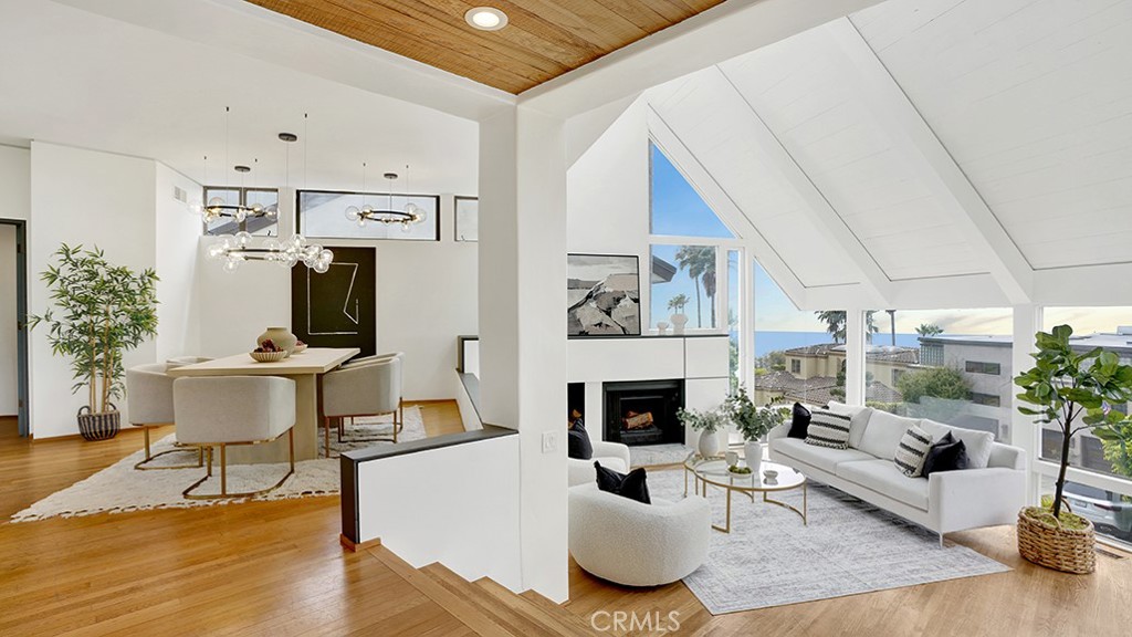 Elevated above the sparkling sands of Victoria Beach, 741 Marlin stands as a masterfully designed retreat in Laguna Beach’s highly desirable Portafina neighborhood. Built in 1982 by architect Timothy Wilkers, a protégé of renowned architect Chris Abel, this transitional contemporary residence harmonizes clean, modern lines with warm wood accents and expansive walls of glass, capturing panoramic ocean vistas and flooding every room with natural light.
A gated courtyard welcomes you to an oversized pivot door that opens to a luminous entryway. The main level flows effortlessly, featuring an open-concept kitchen adjoining a cozy lounge, a vaulted-ceiling living room that extends to a sun-drenched deck, and a guest bedroom with direct courtyard access. The kitchen, appointed with high-end appliances, sleek cabinetry, and a generous island, invites effortless entertaining both indoors and out. A separate family room with fireplace complements a private sauna and standing shower, crafting a tranquil, spa-like sanctuary.
Upstairs, the primary suite is a serene escape, graced with multiple skylights, a spacious walk-in closet, a dual-vanity bathroom, and a private balcony framing breathtaking ocean views. Two additional guest bedrooms share a thoughtfully designed bathroom, completing the elegant layout.
There is potential to add a Jr. ADU above the garage, providing additional space for family, guests, or rental possibilities.
Located minutes from scenic hiking trails, Moulton Meadows Park, pristine beaches, and Downtown Laguna’s shops and galleries, 741 Marlin is a rare opportunity to experience elevated coastal living, thoughtful architectural design, and sweeping views—all in one exceptional home.