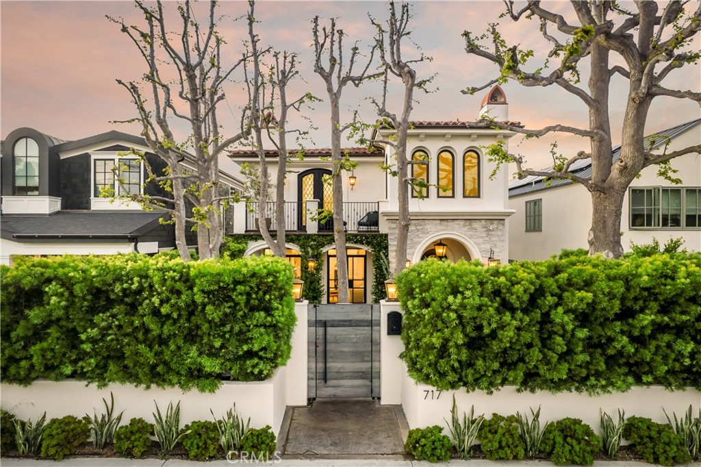 Contemporary Mediterranean with Custom Detail
This custom-quality estate with elevated Architectural Digest-worthy design offers a unique floorplan, upgraded finishes, vibrant outdoor spaces and exceptional curb appeal.
Nestled behind a custom wood gate and high hedges with a spacious, lushly landscaped front yard marked by soaring trees for added shade and privacy, this 4-bedroom, 6-bath, Santa Barbara-style residence features archways draped in jasmine vines and a wrought iron balcony, fusing Old World refinement and a fresh contemporary aesthetic that sets the tone for a high-touch interior featuring coffered ceilings, wood floors, refined fireplaces, neutral hues and Carrera marble throughout.
Highlighting two luminous living spaces that open to both the front and back yard oases featuring tranquil water features, fire pits and a built-in BBQ, the unique floorplan also features a showpiece chef’s kitchen with Thermador appliances, ample storage, walk-in pantry, and eat-in kitchen island with adjacent dining room and dream 175-bottle wine display. Upstairs offerings include the sumptuous primary suite with secluded balcony and ensuite spa bath with marble walk-in shower, sculptural soaking tub and two walk-in closets. Just off the primary suite, a bonus room/flex space is easily transformable for use as a nursery or office/study, while the kids’ wing houses two bedrooms with ensuite baths, in addition to a separate family room that is ideal as a media and hangout space and large enough for conversion into a fifth bedroom.
Outfitted in smart technology, including in-house speakers powered by Sonos and a reverse osmosis drinking water system, the house is prewired for interior and exterior security and also includes three AC zones, an EV charger, two-car garage and parking for four vehicles, plus an elevator.
Located in the Tree Section, the property is mere minutes to the sand and splendors of Manhattan Village and downtown Manhattan Beach.