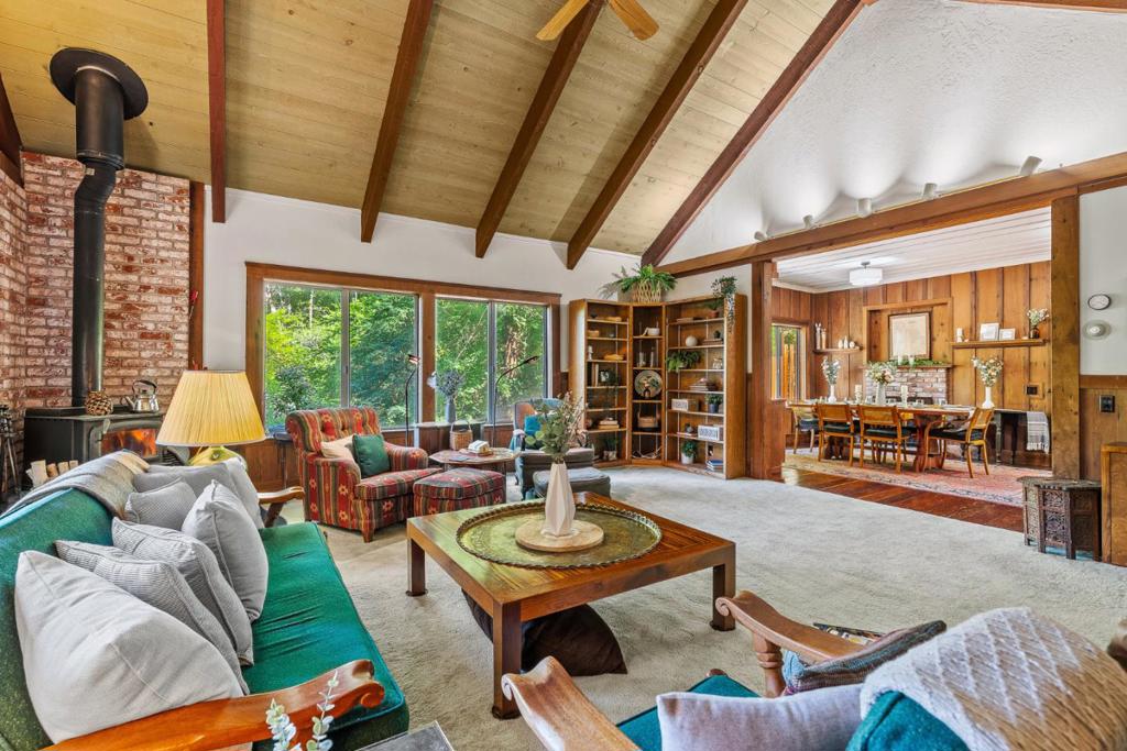 This Brookdale Cabin has been loved by the same family for over 50 years. Now a year round home located near the historic Brookdale Lodge, celebrating the delightful character of the original dwelling with permitted repairs, additions and structural upgrades over time. Enter the foyer (doors to office and kitchen) to the Living Room with soaring ceiling and windows taking advantage of the gentle breezes and mountain views. Gracious dining room with high ceiling, original redwood walls and floors, built in cabinets and fireplace for ambiance. In the kitchen, the laundry is in a closet and a wide window above the sink provides light and views of deck and trees . There are two smaller bedrooms, one across the hall from and one with direct access to the bath with a skylight and true to the character of the home, outfitted with the original claw foot tub. At the end of the hall up 3 steps, the primary bedroom enjoys a sense of sanctuary with peaked ceiling and views. The walk out basement has 3 rooms currently configured as a workshop, his and her hobby rooms-possible ADU? Tesla power wall and generator for backup power. Parking for visitors, deck perfumed by jasmine as low maintenance perennials grace the front yard with some surprise bulbs in springtime!