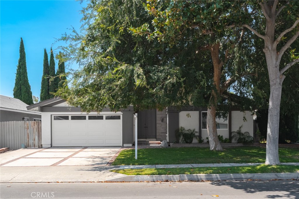 Single story updated home at the end of the cul de sac in Tustin Meadows! Nestled on a lot with so many beautiful shade trees, this home is on the market for the first time in many years. Cathedral ceilings with wood beams gives the appearance of light, bright spacious living. Double door entry leads into the home. Primary bedroom with cathedral ceiling and fan includes mirrored closet doors, vanity with granite countertops and walk in shower. Wood grain luxury vinyl flooring throughout the home, kitchen and baths have tile. Freshly painted with new baseboards, move in ready. The hallway bath has been updated, the other two bedrooms have mirrored closet doors. Wonderful kitchen with space for eat in table/ office/ complete with granite countertops and newer cabinets. Sliding glass door leads the way to the backyard which is equipped with patio cover and a couple of fruit trees. Windows are double paned for maximum efficiency. Two car garage includes the laundry hook ups. Tustin Meadows has low HOA and provides amazing amenities. This home is close to shopping, restaurants, great schools and fwys.