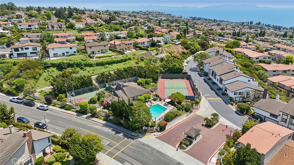This Mira Verde Townhome has it all! Enjoy incredible amenities including Pickleball, Tennis, Basketball, (2) pools and a clubhouse. Wow! Unit has 2 bedrooms and BONUS ROOM on bottom level not included in sq/ft but has 2 oversized windows and lots natural light. Perfect for office/kids/den/workout rooms. Split level floorplan has full bathroom for guest bedroom and a patio off the dining/kitchen area. The outdoor space off the living room is perfect for barbeque and plants and those relaxing days after you come back from playing tennis or having a swim at the pool. Primary bedroom has walk-in closet and his/her sinks as well as a glimpse of the ocean.