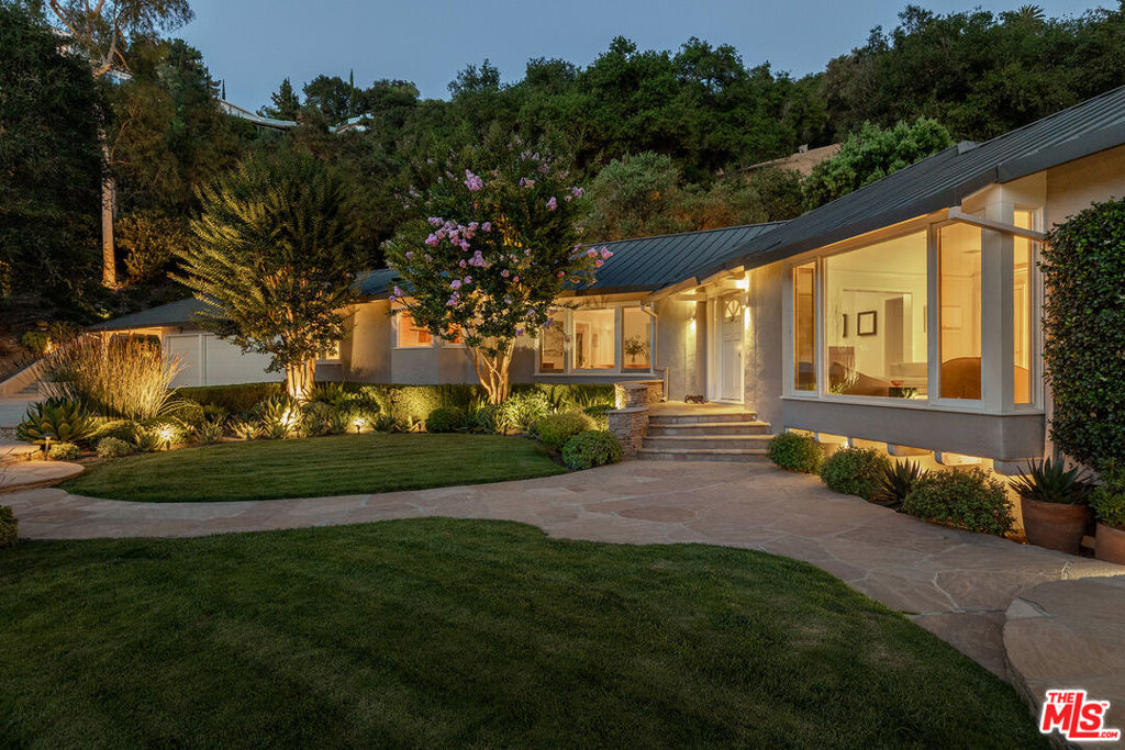 Elegant Traditional meets French Modern. As you enter through the private gate onto the treelined drive and lush garden setting the city washes away. This is it, the place where memories of joyful noise from children playing in the pool, and the voices of friends and guests from near and far whisper on the soft summer breeze amidst the leaves. Perfection. This is everyone's favorite home, the one that the neighbors love. Only three families have lived and raised children in this beloved property over the years adding to its legacy. The interiors of the main home feature Traditional Artisanal and Craftsman Details complimented by French Modern design elements. Upgrades including a Gourmet kitchen with SubZero & Miele appliances, a library, two wood burning fireplaces, formal and casual dining areas, (5) bedrooms ( 1 elevated primary suite + 3 full size bedrooms + 1 maids bedroom near the service entrance), (5) serene, remodeled bathrooms, and a utility area. The Guest House (Bedroom 6) and Pool House together totaling 922 sq. ft. each have private entrances and are included in the total square footage. ( Main House is 3,978 sq. ft. / Guest + Pool House are 922 sq. ft. ) The home, drive, pool, and guest house sit on the front third of a 2+ acre lot. The remaining two-thirds is a gentle hillside with a picturesque oak grove and meadow, thoughtfully maintained to preserve its natural beauty. Intimate. Thoughtful. Private. Welcoming. Will this beautiful home and its quiet natural setting be the next chapter in your story? Come see for yourself.