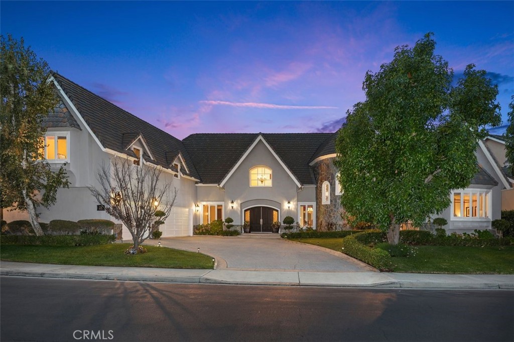RARE OPPORTUNITY - Situated within the prestigious, guard-gated enclave of Canyon Crest, 22187 Westcliff is a custom home that epitomizes refined elegance and timeless luxury, blended with an inviting warmth that welcomes all. This exceptional estate, set on a serene cul-de-sac, is a rare gem in a community renowned for its resort-style amenities. Striking architecture and manicured grounds, framed by a spacious motor court, create a captivating first impression. Inside, East Coast grandeur blends with California’s coastal charm. Exquisite custom millwork, opulent finishes, travertine floors, and curated details craft a luxurious yet comforting sanctuary. Spanning 4,800 square feet, this home is ideal for multi-generational living. Five spacious bedrooms and 4.5 elegant bathrooms ensure comfort. A private upstairs apartment suite—with a bonus room, kitchenette, full bath, bedroom, walk-in closet, and storage—offers versatility. The primary suite, reached via a graceful circular staircase, is a tranquil retreat rivaling top hotels. A spacious downstairs guest suite with a private ensuite bath and separate entrance adds convenience. Meticulous upgrades shine throughout. The chef’s kitchen inspires culinary creativity, while custom bookshelves, wainscoting, tray ceilings in the living room, and beamed ceilings in the family room elevate the ambiance. Milgard dual-paned windows and French doors flood the space with light, and paid solar panels generate surplus energy yearly. The oversized three-car garage, with new epoxy flooring, provides ample space. Outside, a remodeled pebble spa, firepit, and seating areas form a private oasis for al fresco dining and entertaining. Canyon Crest’s amenities elevate daily life: tennis courts, three pools, sport courts, a playground, a gym, a clubhouse, a billiards room, and vibrant social events. Membership at Lake Mission Viejo enriches your lifestyle with recreation and relaxation.
22187 Westcliff is more than a home—it’s a lifestyle, where luxury meets approachable elegance in Canyon Crest’s coveted community.