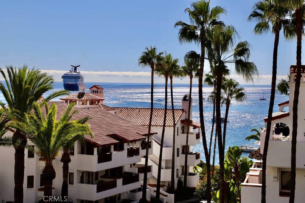 Spectacular Hamilton Cove two bedroom, two bath villa boasting 1,527 sq. ft.. This beautifully furnished, ocean view, corner unit is two levels. Enter on the upstairs level to a large living room, with a wood burning fireplace, and a large wrap around patio with ocean views. Lots of windows bring plenty of light to this villa. The dining room is right off of the living room with a set of french doors leading to the patio. The kitchen is open and airy and includes a breakfast bar, all overlooking the dining and living rooms. It boasts Mahogany cabinets and doors, 4 burner stove and oven, microwave, dishwasher, refrigerator,and trash compactor. There is a separate laundry closet with side by side washer and dryer and mahogany cabinets for storage. The guest bathroom has a single sink and large stall shower. The guest bedroom, with mirrored wardrobe closet, has a ocean view from the bed. Heading down stairs is the entire Master Suite, with plenty of room, large walk in closet, lots of windows and a set of french doors that open to a covered private patio.
The Master bathroom has dual sinks, separate tub, and water closet with a walk in shower. there is also a private entrance to the Master bedroom form the outside stair well. This property is currently a vacation rental and has a one time transferable rental license, and comes completely furnished and includes a golf cart for your transportation needs.