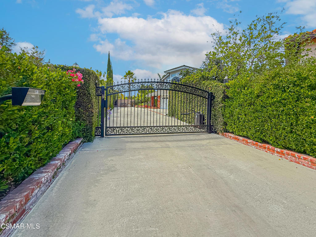 Stunning and Private... Gated Lang Ranch Pool Home with Breathtaking Hill Views - The Ultimate Entertainer's Dream!Prime Location! Nestled on a quiet cul-de-sac near the award-winning Lang Ranch Elementary, this beautifully upgraded 5-bedroom, 3-bath residence offers privacy behind a gated driveway, a spacious 3-car garage, plus ample RV parking or space for basketball.Inside, enjoy a fresh, light-filled interior with freshly painted, crisp white walls, rich hardwood and travertine floors, and designer touches throughout. The chef's kitchen is a dream, featuring a Wolf range, Sub-Zero refrigerator, custom cabinetry, and an open layout perfect for entertaining.This home includes a convenient downstairs bedroom and full bath, a generous primary suite upstairs, and a fully equipped home gym. The resort-style backyard showcases a sparkling pool, spa, and breathtaking views.Just 20 miles from Rams Village in Woodland Hills, this is California living at its finest -- private, polished, and perfectly positioned for everything you need.