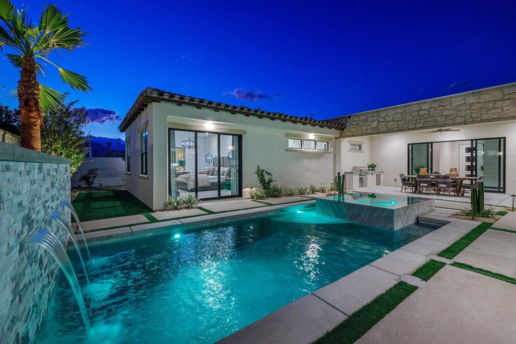 Newly built, model home being sold fully furnished! This is the largest GHA Collection floor plan within the gates of the Province Indian Wells. A seamless blend of Mediterranean architecture and modern design, the home features highly appointed finishes throughout. With 3 bedrooms, including a casita, plus an office and movie theatre. Designed for entertaining, one wing of the home boasts an open-concept design with gourmet kitchen, butler's pantry, walk-in pantry, dining area, family room, and a built-in bar complete with beverage center, ice maker, and a large wine fridge with multiple sliding doors lead out to the pool. The primary suite has a private wing, accessed via a long hallway with clerestory windows featuring an electric fireplace and a spa-inspired bathroom retreat. The third wing of the home includes a bedroom with private ensuite, home theatre, and the attached casita that includes a living area, kitchenette, laundry, and courtyard entrance. Outdoor living features include saltwater pebble-finish pool with colored LED lights, expansive waterfall, built-in BBQ, pool bath, owned solar and more. Just minutes from El Paseo, golf, tennis, dining, and shopping. A rare opportunity to own a turnkey desert retreat, ready for the season and beyond!
