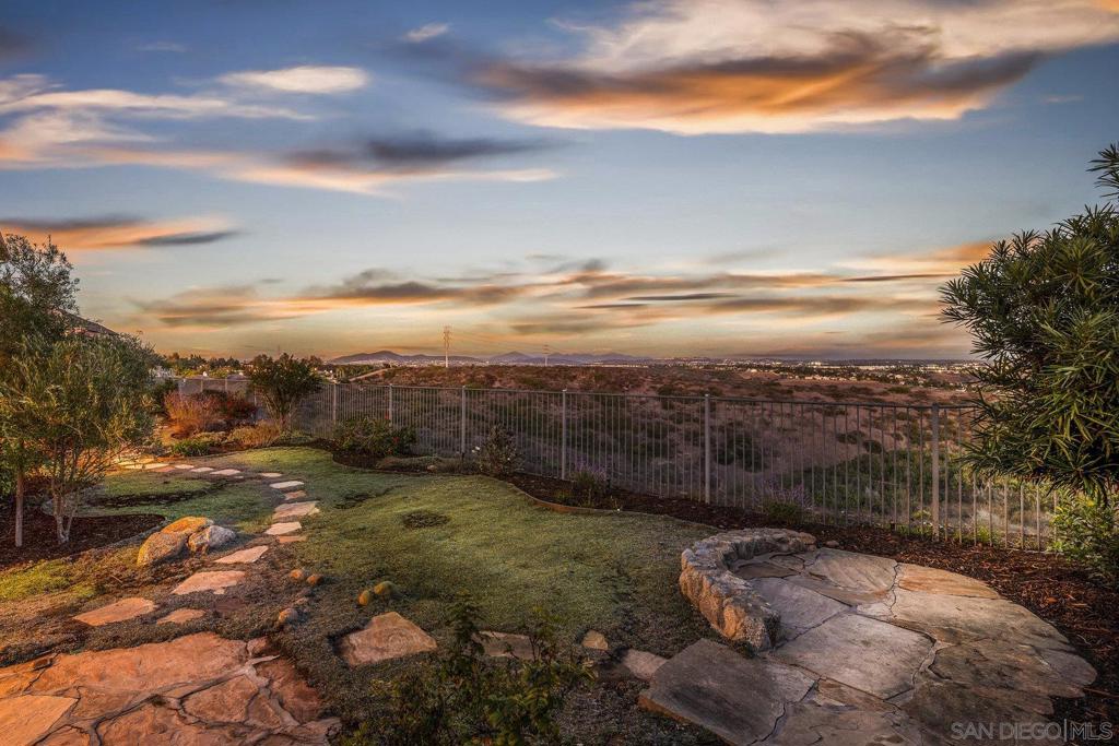 Spectacular panoramic canyon, mountain and evening light VIEWS set on an expansive 8,086 sq. ft. lot, this stunning residence offers unobstructed views from multiple decks, balconies, and thoughtfully designed outdoor living spaces. Situated at the end of the cul-de-sac.The meticulously landscaped yard provides the perfect backdrop for entertaining or simply relaxing and soaking in the scenery. Step inside to find a freshly updated interior — entirely painted in designer tones, including walls, ceilings, trim, and closets paired with brand-new carpet for a crisp, move-in-ready feel. Solid hardwood flooring. A formal entry with soaring ceilings introduces light-filled formal living and dining rooms, a convenient first-floor powder room, and a spacious office or flex space. The open-concept kitchen, breakfast area, and family room feature an oversized island, built-in desk, and custom media center. Solid cherrywood cabinetry, pull-out shelving, Bosch stainless steel appliances, and custom bookshelves enhance both style and function. Upstairs, the seller added a versatile loft with a view window and balcony ideal for a media room, playroom, or gym. The spacious primary suite retreat boasts its own private deck to capture the views, along with a spa-inspired bath offering dual vanities, a sit-down vanity, soaking tub, walk-in shower, and a generous walk-in closet. Three additional bedrooms include one en-suite, while the upstairs laundry room features built-ins and a sink. Additional upgrades include:2019 tankless water heater, Whole-house water filtration system, New exterior light fixtures (2025), Toto toilets in all baths, additional windows added throughout, updated light fixtures in baths, wood flooring, custom built-ins, TWO gas furnaces one for each floor & so much more. Located in the highly sought-after Torrey Hills community, within the Del Mar Union & San Dieguito School Districts, and just one mile from Torrey Hills Elementary. Enjoy nearby shopping, dining, and easy freeway access. This home perfectly blends panoramic views, thoughtful upgrades, and a prime location — don’t miss the seller’s detailed upgrade list!