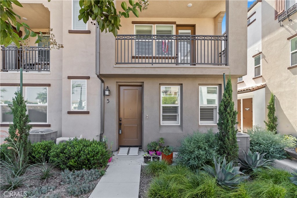 WELCOME TO THE BEAUTIFUL NEWER COMMUNITY OF TOWNES AT MAGNOLIA. Step inside and immediately notice the open and airy living space, highlighted by a multitude of large windows for exceptional natural light. With contemporary style and luxurious finish quality, the entire home has been thoughtfully considered. The entry level offers the first bedroom with a separate full bathroom and the attached, two-car garage with direct access. The first bedroom even has it's own mini-split AC apart from the rest of the home. The perfect open-concept second floor features plenty of modern touches such as recessed lighting, vinyl wood flooring, and an upgraded, chef-inspired kitchen that overlooks the living area and private balcony, perfect when entertaining guests. The kitchen features a beautiful island, sleek countertops, professional-grade stainless steel appliances, and an abundance of modern cabinetry. The third floor has a well-appointed primary bedroom and bathroom, a washer and dryer conveniently tucked away in a separate closet, and the 3rd and 4th bedrooms. The home includes solar panels, which will significantly reduce your electricity bill, as well as a QuietCool system. No need to stress over guest-parking as this community boasts plenty of spots on a first-come basis without the need for any permits. Street parking is also allowed. Conveniently located near many restaurants, markets, shopping centers and easy access to the 5 and 91 freeways.