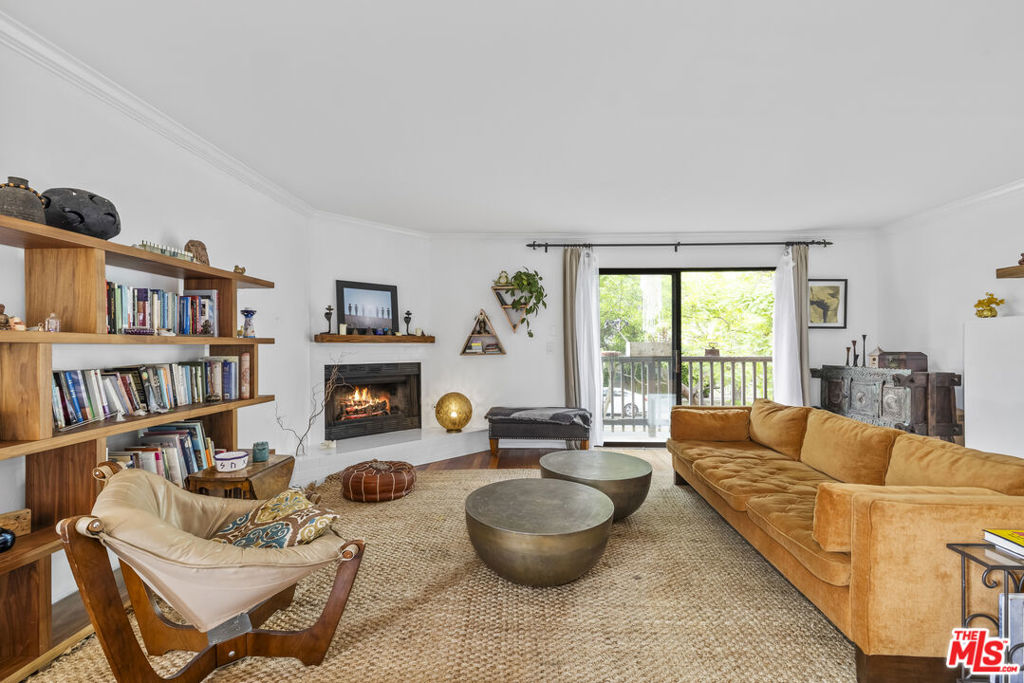 Beautiful townhome close to the beach and Venice Canals! This beautifully designed two-story townhouse offers 2 bedrooms, 2.5 baths, and an open floor plan that seamlessly connects the kitchen, dining, and living areasperfect for entertaining and everyday comfort. Rich Kempas hardwood floors run throughout the home, complemented by two cozy wood-burning fireplaces that add warmth and character.The main level features a convenient half bath with vintage tile and upgraded Kohler fixtures, as well as a side-by-side washer and dryer for added ease. As a front-facing, west-facing home, it enjoys abundant natural light throughout the day and refreshing ocean breezes. Upstairs, the oversized primary suite feels like a private retreat, complete with a wood-burning fireplace, walk-in closet, an additional large closet, and a private terrace where you can relax while taking in swaying palm trees and serene sunsets. The luxurious en-suite bathroom includes a spacious soaking/spa tub and a separate shower. The second bedroom also offers generous closet space and a private en-suite bath featuring custom, beach-inspired tile work. Additional highlights include two dedicated parking spaces, four guest parking spots, and extra storage. This townhouse blends comfort, character, and coastal charm in an ideal location.