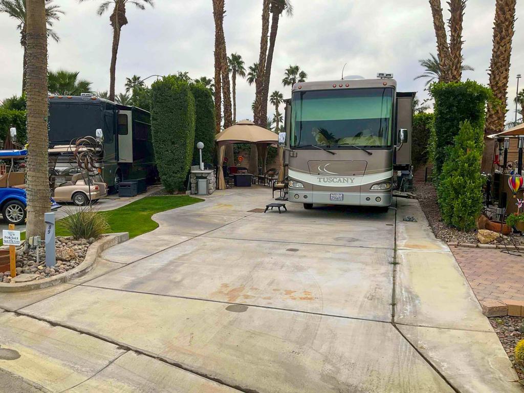 This private perimeter lot in a serene cul-de-sac offers exceptional privacy, ample space for entertaining, and easy back-in access. Its desirable north-facing orientation ensures cooler morning sun and comfortable shaded afternoons, while stunning mountain views enhance the peaceful ambiance. Located in one of the resort's most wind-protected areas, the lot is just steps away from a satellite pool, sauna, and laundry facilities, making it a perfect retreat within this luxury RV resort.Designed for both relaxation and entertainment, this lot features a stylish gazebo with net and canvas drapes, along with a well-equipped outdoor kitchen island complete with a sink, BBQ, and refrigerator. The sale includes all outdoor furniture, such as five wicker club chairs, two wicker loveseats, a glass dining table with four upholstered swivel rocker chairs, a firepit table, and more. Three umbrellas with stands, three storage containers, and a tall propane heater add to the comfort and convenience. A champagne-colored two-seater golf cart with a charger is also included, making it effortless to explore all the incredible amenities the resort has to offer.‍‍