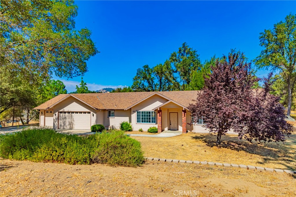 Golfers and non-golfers will appreciate this River Creek Estates custom home.. As you enter the home you note the bay window in the living area which has pocket doors for closing off from the main living area. Family room has a lovely fireplace with raised hearth, lots of windows to take in the back views. Kitchen has a eating bar, walk in oversized pantry and plenty of
counter space. Dining area has been modified to have room for large family meals and french doors to the patio. Master bedroom is quite large with french doors leading to a private patio. Mastervbath includes a garden tub and shower. 3 car oversized garage with 2 roll up doors. Lots and lots of cabinets and workshop area for the handy person in the household. Rv parking with hook ups. Lovely rock out croppings and beautiful trees. All this situated on River Creek Golf Course and located on a quiet cul de sac. Close to Bass Lake and beautiful Yosemite.