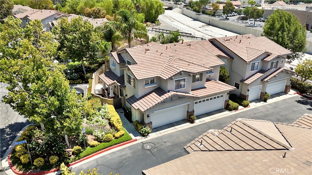 Discover the allure of 26502 Big Sur Drive, where this delightful Valencia gem awaits your arrival. Nestled in the charming Cheyenne Community, this 3-bedroom, 3-bathroom end-unit townhome offers 1,433 square feet of living space, designed to make every square inch count. The airy living room boasts LVT flooring and a cozy fireplace with two large sliding glass windows. The modern kitchen is complete with quartz counter tops, updated backsplash, and newer stove. Full size washer and dryer located downstairs. Upstairs you will find a spacious main bedroom with ensuite. The two additional bedrooms share a full bath. Slide open the large sliding glass doors in the living room to reveal a backyard oasis, beautifully landscaped and fenced for privacy. Enjoy the convenience of a 2-car direct access garage. Lounge by the community pool, unwind in the spa, or shoot some hoops, the amenities have you covered. With so much to offer, 26502 Big Sur Drive might just be the perfect match for your next chapter.