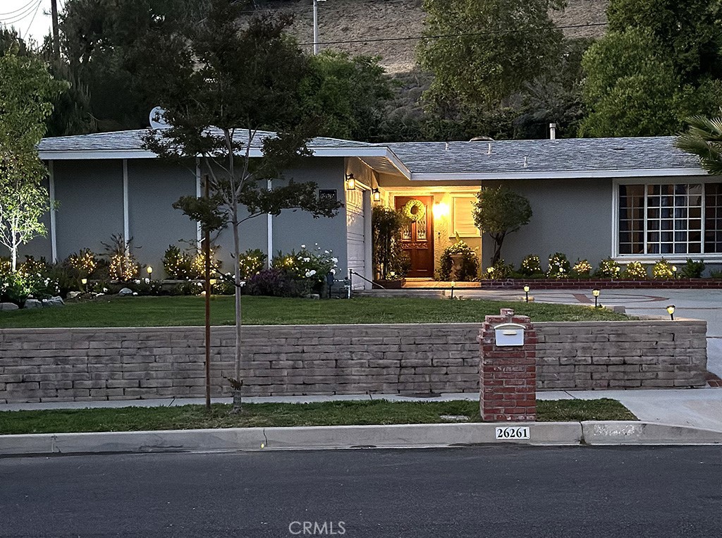 Welcome to 26261 Veva Way, nestled in the beautiful, highly coveted hillside community of Calabasas and the prestigious Las Virgenes Unified School District. Highly competitive loans with rate buydown options available for qualified buyers; ask your agent about rate and other details offered through seller/Broker. No sign on property due to privacy reasons.
Situated on nearly a quarter of an acre against a lovely hillside offering maximum privacy, this stunning oasis is just minutes from shopping, dining, and entertainment, including the nearby Calabasas Commons. A commuter’s dream with easy access to the 101 freeway or take the day off and head 10 minutes south to Malibu Beach.
Enjoy this open, airy floor plan with oversized windows welcoming in plenty of natural light. Charming French doors throughout lead to an entertainer’s backyard with lush, vibrant landscape, a sparkling 721 sq. ft. pool, and covered patio. The newly remodeled kitchen boasts custom cabinetry, crown molding, granite countertops, oversized apron sink, gorgeous hardware, new stainless steel oven, stove top, and hood. The living room, overlooking the beautiful hillside and pool, showcases a marble fireplace framed with custom built-ins and recessed lighting, cleverly hiding an oversized flat-screen TV. Recessed lighting in the living room cabinetry and custom glass hall display cabinets connect with Hubspace App for automated lighting schedules. Elegant crown molding continues throughout. This bright and open, airy concept continues with beautifully remodeled bathrooms with upgraded plumbing. Generously sized bedrooms, walk-in closets, and new hardwood veneer floors. The entire home has been freshly painted inside and out. Outdoor ADT security cameras surround the property offering peace of mind. The list goes on with all attention to detail. Don't miss your chance to make this your dream home!