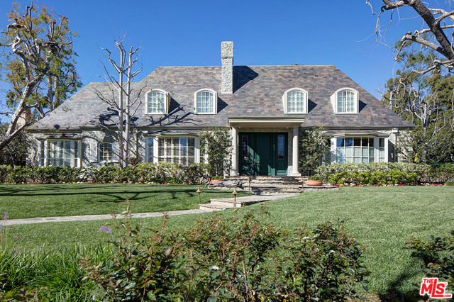 Sprawling Traditional Estate on a sweeping corner lot with mature trees and broad frontage on extremely desirable North Bristol Avenue in Brentwood Park. Situated behind gates on over 22,000 square feet of land, this custom-built, mostly single-story home is available for the very first time. Wonderful street presence, grand scale spaces, high ceilings, rich hardwood floors and finely crafted millwork throughout. Large foyer leads to formal dining room and library with fireplace, each with radius bay windows. Formal living room with tall beamed ceilings, stone fireplace, bar and French doors opens to stone patios and private grassy yard. Four bedroom suites, including fabulous master with French doors, fireplace, lavish dual baths & closets and separate gym. A rare opportunity to enjoy a gracious and elegant home on a fantastic lot in the very best Brentwood location.