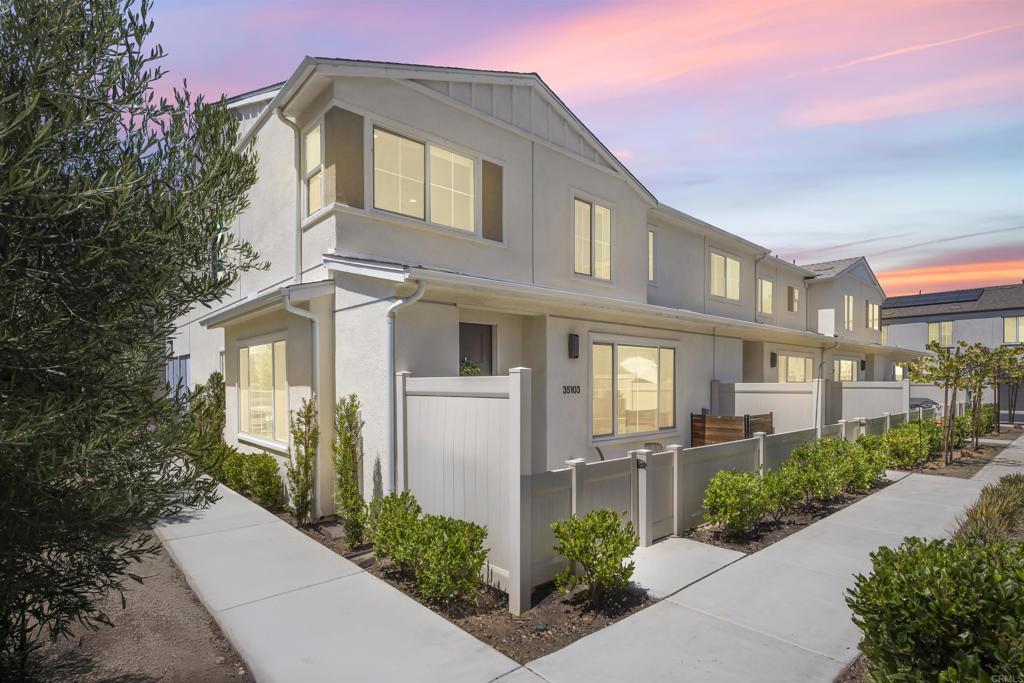 Set in the heart of Citro, Fallbrook’s premier community, this rare corner-unit blends contemporary design with a vibrant, outdoor lifestyle. This 4-bedroom, 3-bath, 1,471 sqft residence combines elegant finishes with everyday functionality. The kitchen features a large island, quartz countertops, stainless steel appliances, large pantry, water softener, and abundant storage—perfect for both casual meals and entertaining. A flexible 4th bedroom offers space for a private office or game room, while light-filled living areas open to a welcoming front porch. Additional highlights include a stackable washer/dryer, attached 2-car garage with extra storage area, and energy-efficient leased solar. Citro offers 235 acres of open space, 14+ miles of trails, a community garden, bocce ball court, clubhouse, dog park, and a resort-style pool/spa—all surrounded by scenic avocado and citrus groves.