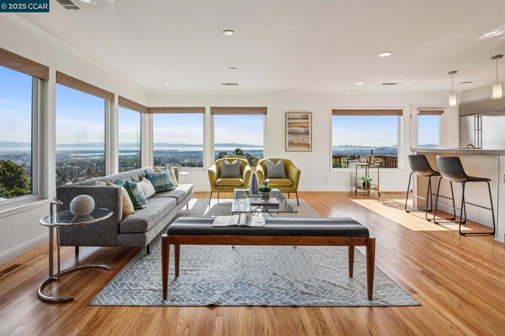 Experience modern California living in this stylish Crestmont home with sweeping Bay views. The sundrenched main level features open living and dining spaces with panoramic vistas, a cozy fireplace, and seamless access to the exterior deck. The home has been loved by the same family for 26-years. The kitchen is a chef’s dream with stainless steel appliances, a Thermador range, concrete countertops, and abundant cabinetry. Three bedrooms, including a serene primary suite, are thoughtfully arranged on the main level. California shutters bring timeless charm to the bedrooms, while central air conditioning ensures year-round comfort. Downstairs, a spacious family room or versatile guest suite with a private bathroom, provide plenty of flexibility for entertaining or extended stays with a wet bar and mini fridge. Beyond this is a private office space. An enclosed front patio offers a quiet retreat, while the beautiful setting makes the most of Oakland’s stunning sunsets, with nearby shopping, parks, trails, and transportation. With a perfect blend of sophistication, comfort, and function, 485 Creighton Way is designed for those who love to entertain, relax, and truly enjoy the best of Oakland Hills living. 485Creighton.com