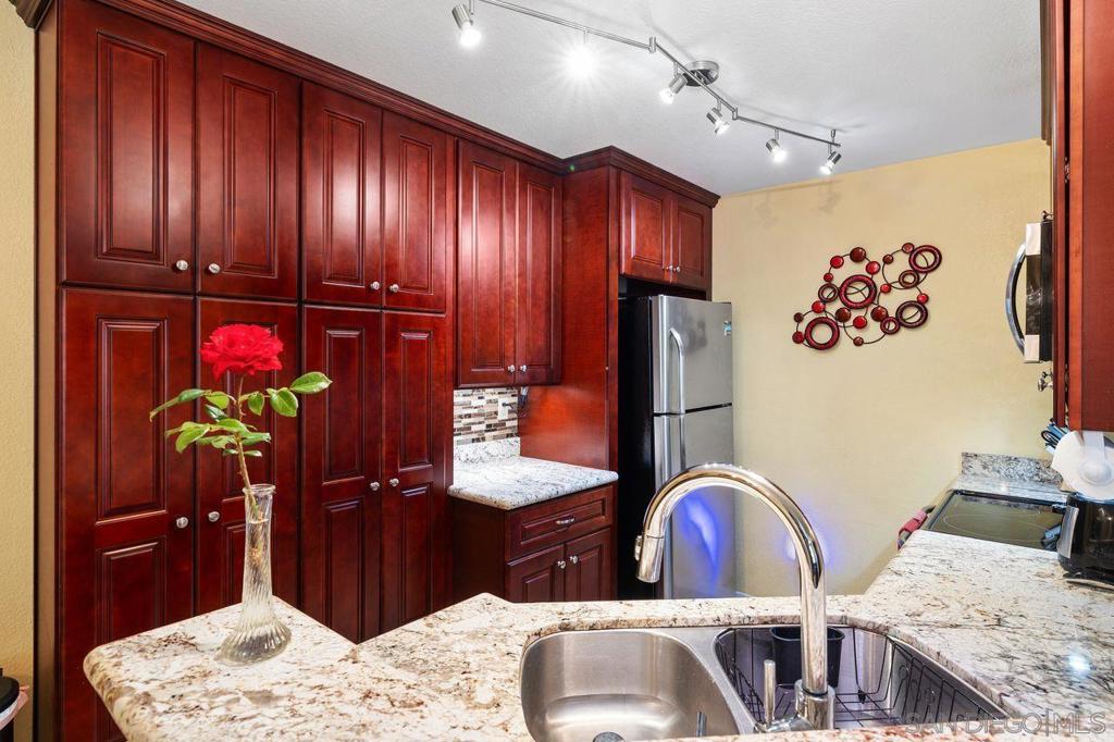 Charming Fashion Valley Condo – Comfort & Convenience in One! Welcome to this beautifully maintained two-bedroom, two-bath condo in the heart of Fashion Valley. Designed for easy living, this home offers a rare direct entry from the parking area—the tandem garage is located just across the hall, so you’re only steps from your front door with no stairs at all. Inside, the thoughtful floor plan features separate bedrooms and baths for privacy, perfect for guests or a roommate. Highlights include gorgeous cherry kitchen cabinets that soar to the ceiling, granite kitchen countertops, laminate and carpeted flooring, a newly remodeled huge walk-in shower with a convenient seat and glass enclosure, indoor stackable laundry, recently installed A/C and furnace, a cozy fireplace, and a spacious patio for outdoor relaxation. The community offers a heated saltwater pool and a fully equipped workout room, all surrounded by tree-lined streets and a prime location just minutes from Fashion Valley Mall, dining, beaches, and downtown. Experience the best of Fashion Valley living with this perfect blend of comfort, convenience, and lifestyle. Property Highlights • 2 Bedrooms / 2 Bathrooms • Rare direct entry from parking area – tandem garage just across the hall, no stairs • Gorgeous cherry kitchen cabinets that soar to the ceiling • Granite kitchen countertops • Laminate and carpeted flooring • Remodeled huge walk-in shower with convenient seat and glass enclosure • Indoor stackable laundry • Recently installed A/C and furnace • Cozy fireplace • Spacious patio for outdoor relaxation Community Amenities • Heated saltwater pool • Fully equipped workout room • Tree-lined streets • Prime location near Fashion Valley Mall, dining, beaches & downtown