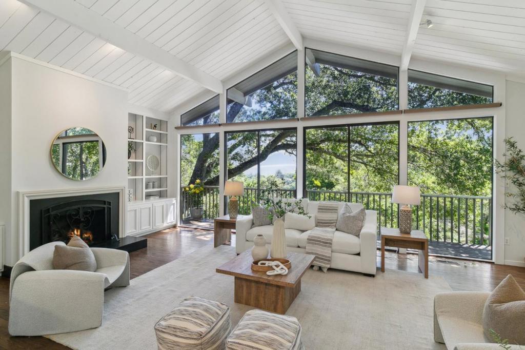 Elegant Hillsborough Retreat with Bay Views, nestled in one of the Hillsborough most picturesque settings. Surrounded by majestic heritage oaks, this beautifully renovated single-level home showcases expansive interiors and walls of windows framing tranquil views of lush gardens and the San Francisco Bay. Featuring 4 bedrooms and 2.5 bathrooms, the layout offers refined style and exceptional livability. The spacious living room boasts soaring vaulted ceilings and a dramatic wall of windows opening to a wide-view balcony, inviting in natural light and serene Bay vistas. A large formal dining room provides the perfect setting for entertaining, while the adjacent chefs kitchen with a central island and top-tier appliances overlooks the inviting family room with direct access to the private backyard. Enhancing features include al fresco dining patios, a built-in BBQ, generous storage, a spacious two-car garage, and a detached finished shed-ideal as an artists studio or private office. Every room enjoys total privacy and serene views of the surrounding natural landscape. This exceptional property is served by award-winning Hillsborough schools and offers a prime location with convenient access to SFO, San Francisco, and Silicon Valley.