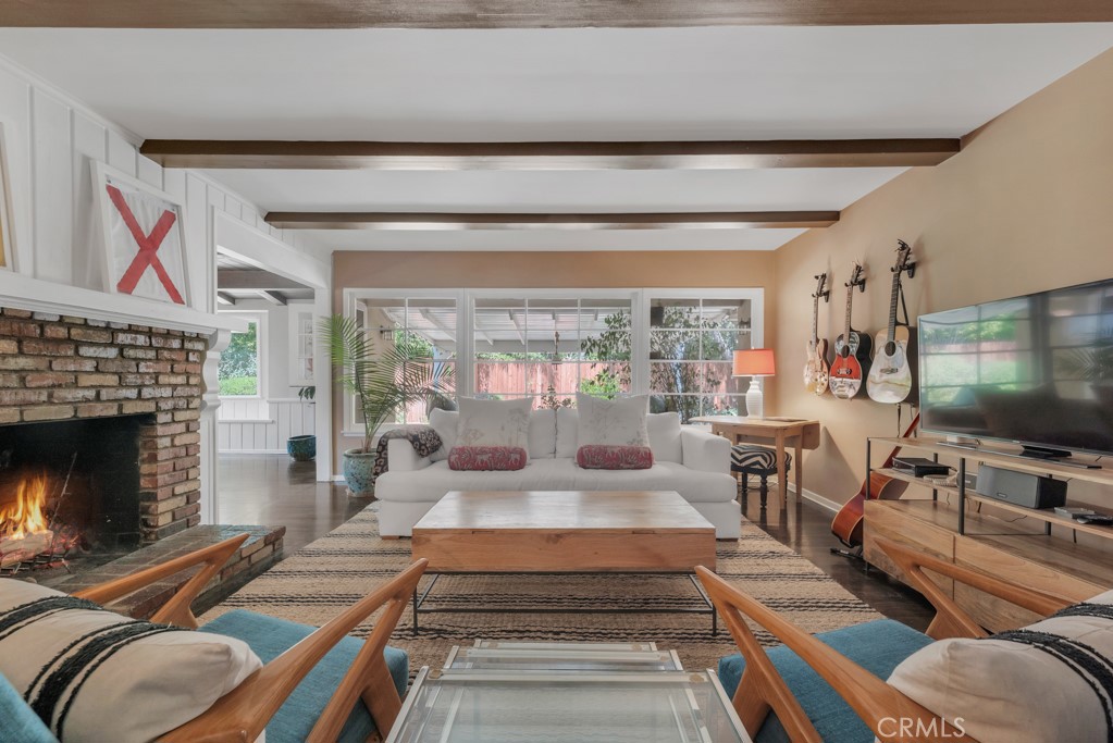 Charming Woodland Hills Home in a Picturesque, tree-lined neighborhood. Nestled South of Ventura Blvd., this delightful home is located on a peaceful street surrounded by beautiful mature trees. Conveniently situated just a few blocks North of Mulholland Drive, with easy access to the shopping hubs of Woodland Hills and Calabasas, and only minutes to the beach. The long-term owner has lovingly maintained and updated this welcoming residence, making it an inviting retreat. This spacious 3 bedroom 2 bath single story home exudes warmth and a homey vibe the minute you walk in. Open the front door and immediately you will notice the large window overlooking the covered patio and outdoor area. The living room offers a cozy brick fireplace and built in shelves, perfect to display books or special mementos. There is a dutch door that leads to the covered patio, bringing the outdoors in. Wood floors throughout home, with tile in bathrooms. Newer HVAC system, roof, tankless water heater and more. Bring your toothbrush and imagination.