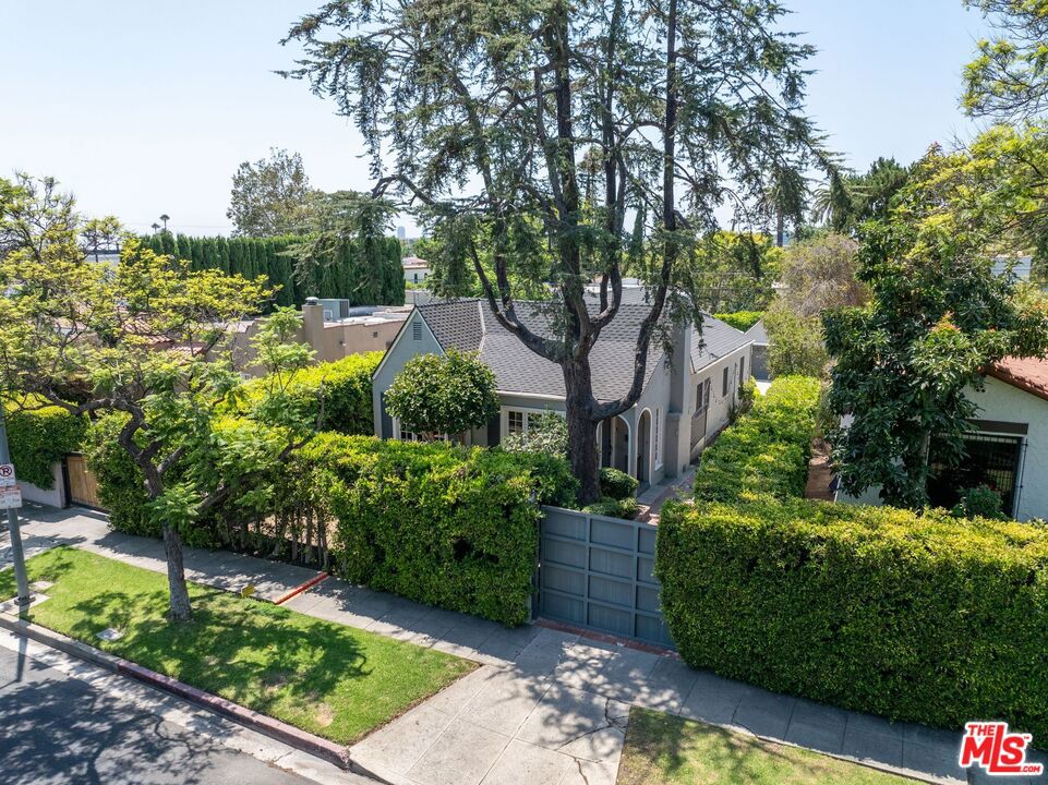 Welcome to 749 N Crescent Heights, a peaceful and inviting traditional four-bedroom, two-bathroom home nestled behind tall privacy hedges and an electric gate. This mini compound offers a rare sense of seclusion right in the middle of one of LA's most vibrant neighborhoods. The layout is warm and functional, with two spacious primary bedrooms located at the back of the home, each opening through French doors to a private patio and sparkling pool and spa. The fourth bedroom is perfect for a home office, guest room, or creative studio, giving you the flexibility to make the space your own. Inside, the living room is centered around a wood-burning fireplace and flows into the dining area and kitchen, where you'll find a Fisher & Paykel refrigerator, Kenmore Elite double oven, gas stove, grill, and a brand new Bosch dishwasher. The home also includes new central A/C and heat, a new washer and dryer, an alarm system, and built-in speakers throughout. The detached two-car garage plus a long driveway behind the gate that can fit 4 mote cares. This property also includes bonus space above the garage, offering potential for an ADU, gym, studio, or a guest suite. Whether you're looking for a move-in ready home or a property with room to update, renovate, do an addition, ground up construction, add an ADU, this home has the optionality and checks all the boxes. The location is unbeatable! Moments from Melrose Place, The Grove, the Original Farmer's Market, Alfred Coffee, Tartine, Urth Caff, Trader Joe's, and countless restaurants, boutiques, and cafes.This is a truly special home with a cozy feel, great energy, and lots of possibilities for living, relaxing, and creating. ***OFFERS DUE TUESDAY AUGUST 26TH AT 5:00PM*** Owner reserves the right to accept offer at any time.