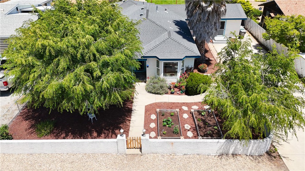 Beautiful well kept home sits on a quiet dead end street. Enter to a private court yard with garden beds. There are 2 entrances to the home, home boasts over 2300 sqft of living space, and almost 1/3 of an acre plus alley access to the backyard. Build your ADU or garages. Formal living room with beautiful laminated flooring, remodeled kitchen with large breakfast bar, walk-in pantry and recessed lighting. 3 Bedrooms, 2 full baths, master is on the opposite side of the home. Enter into this huge family/dining/great room with tongue and groove vaulted ceiling, wet bar with brass foot rails, bar was original Jacko's Steak House. Lots of built-ins, and floor to ceiling dual pane windows that faces the sunny backyard with huge covered and uncovered patio, SM style brick BBQ for your enjoyment. Beautiful laminated flooring throughout the home, and dual pane windows, one of the bedrooms has bay window, overlooking the front of the home. Home has Central air condition and ceiling fans for those warm summer days, There's a work shop and storage room with 220V attached to the home, plus a 20x24 workshop with a10 ft roll up door, maybe converted to a garage. Side of home has a huge driveway, park your RV or more than 2 cars can fit. I am told that Nipomo has the best weather on the Central Coast. Close to all major shopping centers, restaurants etc. Home has so many possibilities, its a must see and move in ready.
