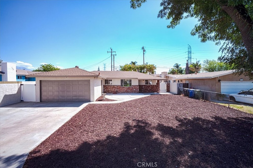 Beautifully updated 4br, 2 bath home on tree lined Azusa street! This open concept home shows cool and sophisticated, with contemporary marble patterned flooring, warm neutral wall color throughout, recessed lighting, and updated windows. The spacious living room boasts a white slump stone fireplace, and opens to the dining area and stunningly updated crisp white kitchen with shaker cabinetry, quartz counter tops and gleaming stainless appliances, worthy of any chef! The N wing of the home has four private bedrooms and two completely remodeled bathrooms. Entertaining will be a breeze in this fantastic back yard, which includes a covered patio with three ceiling fans, spanning the length of the home, and a refreshing pool and spa complete with a diving board! The two car garage has been converted to additional living space, perfect for a home office, gym, teen/bonus room and an infinite list of additional possibilities, or easily convert back to a functioning garage! The enclosed laundry room has additional storage and leads to the exterior. The updated electrical and panel, newer water heater, close proximity to schools, parks, and the 210 freeway, all make this a wonderful place to call home!