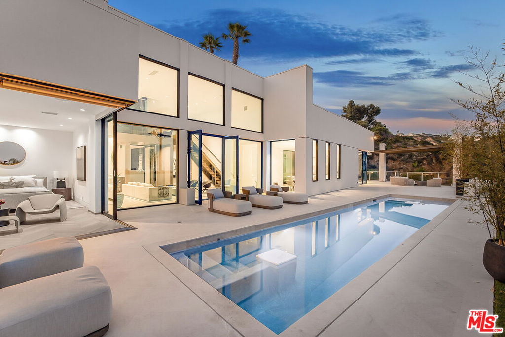 Escape the city in this striking contemporary estate, reinvented and designed by Nicole Sassaman. Located at the top of the Bird Streets, this gated compound offers sweeping panoramic views of Los Angeles and is perfectly suited for those who love to entertain in style.Inside, soaring 20-foot ceilings set the stage for a dramatic architectural experience. The home features 5 bedrooms and 6.5 bathrooms, finished with the highest level of craftsmanship and designer detail. Exceptional amenities include a private screening room, loft, expansive yard, resort-style pool, and TWO full Poliform kitchens with Gaggenau appliances, ideal for chefs and entertainers alike.The luxurious primary suite includes a spa-like bathroom and a two-story custom closet. Car enthusiasts will appreciate the rare parking capacity, with space for 10+ vehicles in the gated motor court plus an attached 2-4-car garage.A true one-of-a-kind property in one of the most desirable locations in Los Angeles.