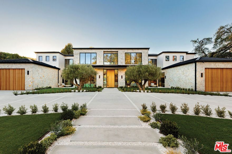 A masterpiece of comfort, design, and effortless luxury, this estate is thoughtfully curated by Studio Brinkley Design and delivers a lifestyle where every detail has been considered and nothing has been overlooked. The newly built residence spans over 10,000 square feet, offering unparalleled design and thoughtful craftsmanship. The grand foyer, with its soaring ceilings, welcomes you to an inviting formal living room featuring a striking fireplace, custom built-ins, and a sophisticated wet bar that flows seamlessly into the family room and chef's kitchen. Designed for both everyday living and effortless entertaining, the kitchen is a true centerpiece with double islands, Taj Mahal quartz countertops, chef-grade Wolf appliances, a walk-in pantry, and a full secondary prep kitchen. Sunlight fills the breakfast nook while expansive sliding doors create a perfect connection to the resort-style backyard. A glass-encased wine wall highlights the formal dining room, positioned adjacent to a private office that can also serve as an additional bedroom. The opposite wing of the home offers a spacious lower-level entertainment suite, complete with custom built-ins, a game and lounge area, and a dedicated home theatre, perfect for both hosting and relaxing. Throughout the residence, elegant paneling, designer finishes, and a state-of-the-art Control4 smart home system providing seamless automation for lighting, climate, security, and audio-visual experiences. A stunning staircase leads to four beautifully appointed en-suite bedrooms, including the primary retreat, a serene sanctuary with a fireplace, built-in wet bar, and two separate balconies, one offering a feeling of complete privacy with an outdoor sauna. The spa-inspired primary bath has dual vanities, a steam shower, a soaking tub, and an expansive custom closet. The backyard is an entertainer's paradise, with patios stretching the full length of the home, a covered outdoor living room with fireplace, a sparkling pool and spa, a fire pit, putting green, and sport court. A built-in barbecue area and pool house with an en-suite bath complete the resort-style setting. Additional features include an attached ADU with a private entrance, one bedroom, bath, and a versatile living area that can serve as a lounge, studio, or gym, ideal for guests or multigenerational living. The estate also offers a gated circular driveway and a two-car garage, all ideally positioned just moments from premier shops and celebrated local restaurants.