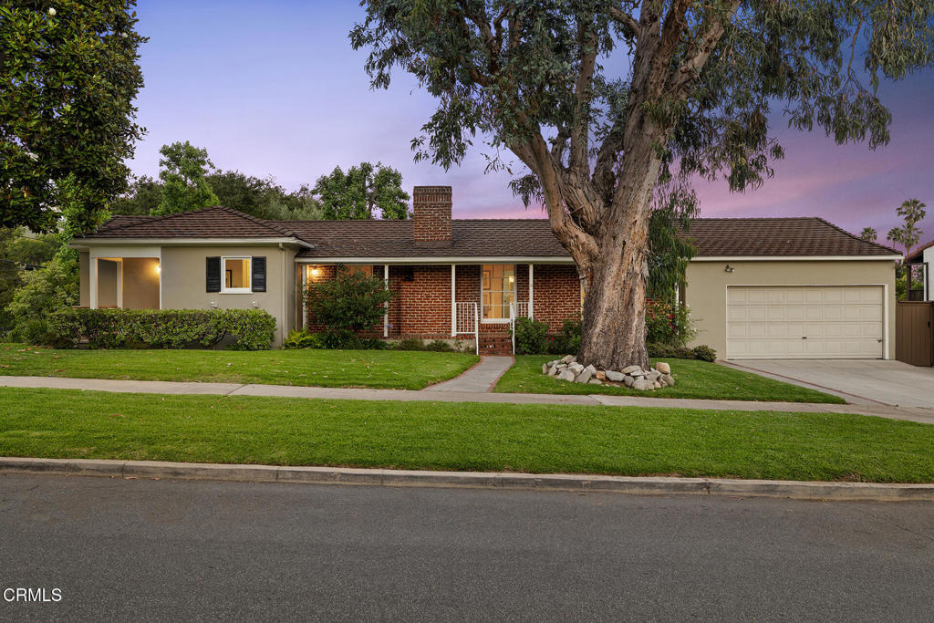 Set on an expansive double lot in the premier East Altadena neighborhood, this charming single-level mid-century ranch offers incredible space, privacy, views, and exceptional indoor-outdoor living. With 3 bedrooms, 3 bathrooms, a family room, den, office (which could serve as a fourth bedroom), and a pool and spa, this home is designed to meet a variety of life's needs. Mature landscaping and brick-lined pathways lead to a double-sided formal entry and inviting covered porches. Inside, the grand living room is bathed in natural light and showcases attractive period details including a tray ceiling, hardwood floors, built-in shelving, and a decorative fireplace. The generous formal dining room features large windows and classic moldings. French doors lead to an oversized family room and adjacent den providing versatility for everyday living and entertaining. The updated kitchen is open to both the den and dining room with a breakfast area at the opposite end, creating a fantastic flow to maximize utility. Located in the north wing, the primary bedroom features dual closets and direct access to both the office and a beautifully updated bath with separate tub and shower. The second bedroom includes a delightful bay window with serene mountain views, and the third bedroom is conveniently located just off the kitchen with its own dedicated full bath. A third bathroom with shower is situated off the den and ideal for guests. A dedicated laundry area includes a utility sink, pantry, cabinetry, and provides access to both the outdoors and the attached garage. Private outdoor spaces await your enjoyment including an elevated wood deck with retractable shade, hardscaped patio areas, lush landscaping, grassy lawns, and a gated pool and spa. There's also a dedicated RV parking space that can easily be transformed into additional play or flex space. Further highlights include two zone HVAC with newer condensers, 26 solar panels, copper plumbing, EV charger, and fresh interior paint. Well cared for and turnkey, this exceptional property is mere blocks from Pasadena with vibrant shopping, dining, and transit options nearby and is ready to be enjoyed by its next, lucky owner.