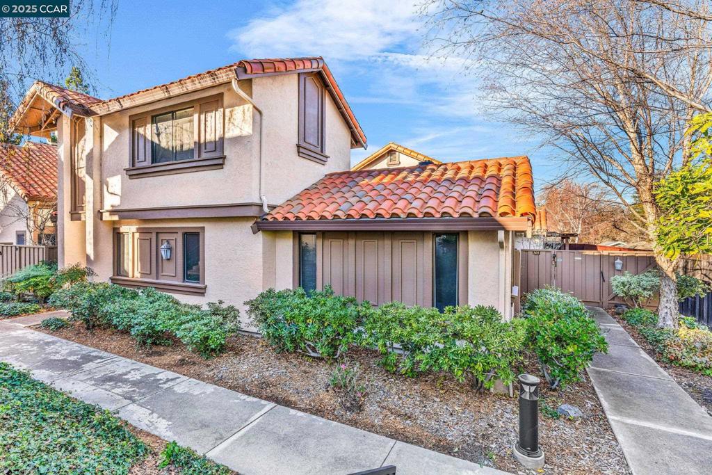 Welcome to this refined two-story townhome in sought-after Main Chance Estates with attached 2 car garage. Enter through a private gate & cross a serene koi pond to the outdoor terrace. Inside, the living room features a fireplace & built-in shelving with hidden storage. The adjacent formal dining room provides an elegant space for entertaining, while a half bath & storage closet add convenience. The well-appointed kitchen boasts stainless steel appliances, ample storage, an island, a breakfast nook & a skylight that bathes the space in natural light. Sliding glass doors lead to a covered patio, perfect for alfresco meals. The main-level primary bedroom offers a peaceful retreat with sliding doors to a private courtyard. The ensuite bathroom includes a shower with dual shower heads for a spa-like feel. Upstairs, two bedrooms each feature dual closets. The hall bathroom includes a tub/shower combo with dual shower heads & a separate water closet for added privacy. Additional highlights: a two-car garage & access to HOA amenities, including a pool, spa & tennis courts. Close to downtown Walnut Creek shopping, restaurants, parks, trails, 680, BART & top-rated schools.