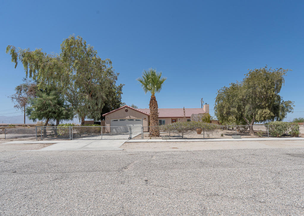 Spacious and well-maintained 3-bedroom, 2-bath home in Salton City, offering privacy, comfort, and a touch of desert charm. The property is fully gated, with a rear gate providing convenient access for off-road adventures. Both the front and back yards are beautifully landscaped with mature plants and trees, creating a peaceful outdoor retreat. Inside, you'll find generous living space throughout, with a layout that's both functional and inviting. The home is in great shape and ready to enjoy. A large storage unit in the back is perfect for tools, recreational gear, or hobbies. This is a fantastic opportunity to own a move-in-ready home with plenty of space and the perfect setup for desert living.