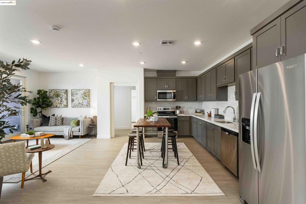 Turnkey new construction! This is a flat 1,369 square foot 2 bedroom 2 full bath and den home with a beautiful open floor plan and designer interior finishes. The floor plan features a spacious kitchen, living, and dining room area that opens onto a deck. There is a walk-in closet in the primary bedroom and more storage options throughout the home. The community will feature a dog park, overlook park, and a public walking trail within the community. Great location and a short walk to BART. Easy access to the 880 and 580 for commuters. Shopping and a variety of terrific restaurants are close by. Images shown are of a similar unit.