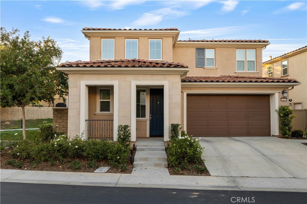You will be in awe of this updated West Creek home. Very desirable end unit location with front porch, large backyard with no rear neighbor.  Once inside, you are greeted by a freshly painted home with tile and wood vinyl floors and plenty of natural light throughout. The kitchen features an eat in island, separate dining area, GE appliances and includes the refrigerator. Living room is open to the dining area with plenty of windows open to the back yard.  Heading upstairs you will love the new carpet, fresh paint and high ceilings. The primary suite offers plenty of space with walk in closet and connecting bathroom with dual vanity sinks, separate soaking tub and walk in shower. The upstairs laundry room offers convenience with additional storage. Spacious secondary bedrooms each have walk in closets and share a dual sink bathroom. The private backyard with no rear or side neighbor is done simply for you to enjoy with custom pavers, a firepit with seating area, vegetable garden, grape vines and plenty of space to relax and play. There is an attached direct access two car garage with a Tesla charger. Added benefit is the owned Solar power, tankless water heater, Nest controls, LED's throughout.  All schools; West Creek Academy , Rio Norte Jr. High and Valencia High are highly rated and walking distance from the home. This luxury community includes 3 entertaining areas with pools, jacuzzi, fireplace, sports courts, barbecue picnic area, and beautiful grounds throughout. This is a must see !