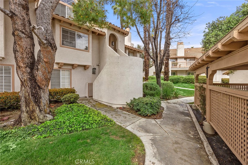 This beautifully updated upper corner unit in the Briosa community is a rare find and offers one of the largest floor plans available, featuring 2 bedrooms and 2 bathrooms. Recently remodeled throughout, the home showcases vaulted ceilings, an open layout, new wood laminate flooring, matching granite countertops in the kitchen and bathrooms, stylish vessel sinks, dual-flush high-efficiency toilets, new faucets and fixtures, a new garbage disposal, and a gas fireplace. The kitchen is equipped with high-end Samsung stainless steel appliances, including a 5-burner gas range. Additional highlights include central A/C and heating, two walk-in closets, an indoor laundry room, a detached one-car garage, and an additional permitted parking space. A spacious private patio with an extra storage closet completes the home. Residents of the Briosa community enjoy access to a pool, spa, barbecue and picnic areas, a playground, and a basketball court.