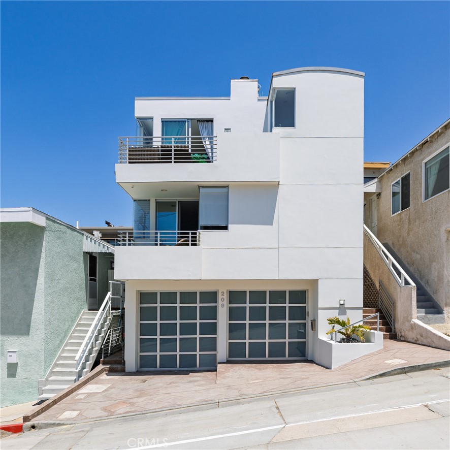 Located in the heart of Manhattan Beach’s coveted El Porto neighborhood, 209 41st Street offers stunning unobstructed ocean views and coastal living just a few steps from the beach. The top-floor great room bathes in natural light and offers sweeping ocean views from every angle. Watch the sun set from your private balcony, unwind by the fireplace, or entertain from the open-concept kitchen—complete with bar seating and seamless flow into a view-rich dining area. A stylish powder room with ocean vistas completes the top level.
The mid-level entry opens to a spacious secondary suite featuring a walk-in closet, en-suite bath, and expansive ocean views. The primary suite is a private retreat, with its own balcony, custom barn door, dual vanity bath, and glass-enclosed shower—all set against a stunning coastal backdrop. Downstairs, the third bedroom with full bath is perfect for guests or a home office, alongside a generous two-car garage with epoxy floors, laundry, and storage. Fresh carpet, refinished hardwoods, and a central vacuum system enhance comfort in this move-in ready beachside gem.