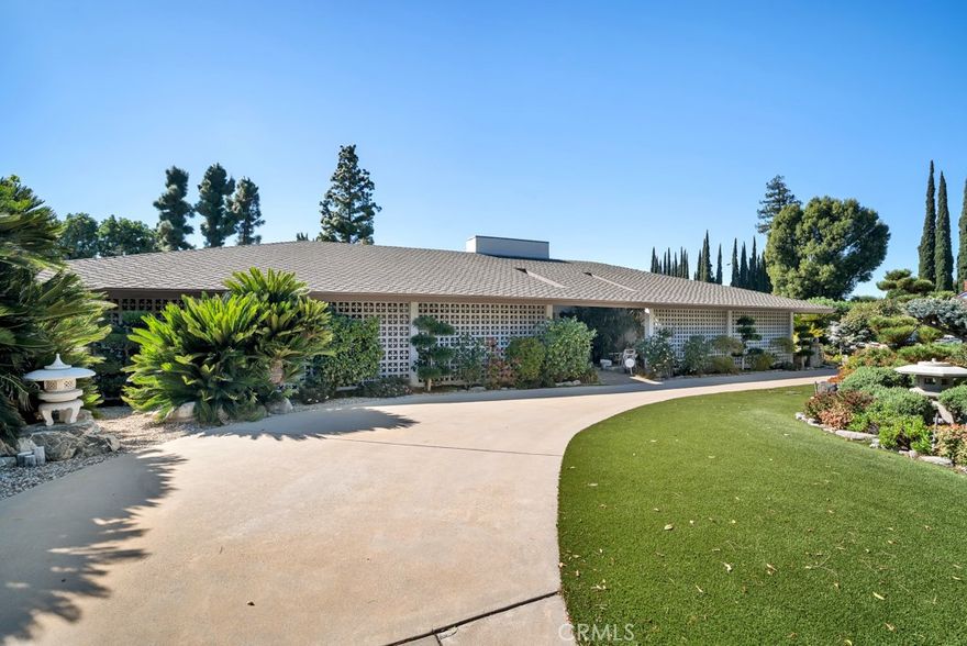 Welcome to this exceptional corner-lot home, perfectly situated on a generous .32-acre lot in one of Porter Ranch’s most sought-after neighborhoods. Surrounded by custom landscaping, this residence offers the ultimate in indoor–outdoor living with a resort-style backyard featuring a large lap pool, separate built-in Jacuzzi, and a built-in BBQ area — ideal for entertaining or relaxing in style. Step inside and experience the thoughtful design and custom accents throughout. The spacious, open-concept kitchen flows seamlessly into the dining and living areas, creating an inviting space for gatherings. The chef’s kitchen boasts ample counter and cabinet space, two brand-new stoves, and two separate ovens, making it a dream for cooking and entertaining. Elegant custom cabinet hardware adds a sophisticated touch to the home’s well-curated design. The family room features a large custom fireplace, adding warmth and charm to the expansive living space. The primary suite is a private retreat with a beautiful ensuite bathroom and peaceful views of the professionally landscaped side patio. Three additional bedrooms share a stylishly full bath, while a fifth bedroom with its own ensuite bathroom—located on the opposite side of the house offers flexibility for guests, a home office, or extended family. Additional highlights include a spacious laundry room with washer and dryer, fresh interior paint, brand-new carpeting, and an attached two-car garage. Enjoy luxury living with easy access to nearby parks, nature trails, premier shopping centers, fine dining, and highly rated schools. This home truly combines comfort, elegance, and functionality—an entertainer’s dream in the heart of Porter Ranch! PLEASE MAKE A NOTE THAT THE FIREPLACE IS DECORATIVE ONLY.