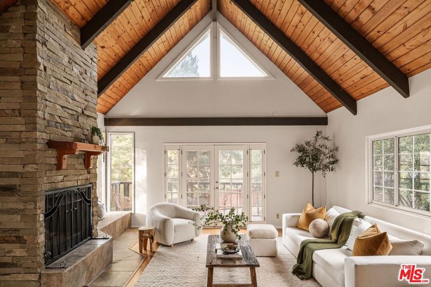 Nestled in the heart of Topanga, this enchanting treehouse-style Traditional home offers a serene and whimsical retreat in the heart of one of Los Angeles' most inspiring enclaves. Step inside and find a harmonious blend of rustic charm and modern comforts, with unique finishes and handcrafted details that infuse every room with character. Perfect for a creative soul looking for a separate studio, home office, or guest house, or a Buyer looking for an investment opportunity to rent the primary residence and/or well-appointed guest house, this provides various options for living in this idyllic community. With soaring vaulted ceilings and stunning architectural elements throughout, the home boasts an airy, open atmosphere that perfectly complements the lush natural surroundings. Expansive windows fill the home with an abundance of natural light and provide breathtaking views of towering trees, vibrant grounds, and mature fruit trees that encapsulate the property. The open living spaces flow seamlessly - ideal for both cozy family gatherings and entertaining on all scales. Relax and unwind in the living room, complete with a dramatic stone fireplace and French doors that open to a balcony. A large dining room features a charming seating area/den, and walls of glass that open to an expansive rear deck that leads seamlessly into the gardens below. The kitchen is well-appointed and offers custom cabinetry and professional-grade appliances - ideal for an intimate dinner or hosting events on all scales. 3 bedrooms complete the main residence, while the lower-level guest house comes with its own kitchen, open living and dining area, bedroom, and additional space currently utilized as a gym. The exterior grounds make this property a true oasis complete with an expansive turf lawn that features various sitting and entertaining areas in the shade of mature oak trees. Lose yourself in the serene walking paths and various "moments" that feature a multitude of locations to take in this coveted natural ambiance. A variety of terraces provide space to relax and unwind and enjoy various luxuries that include a hot tub, swim spa, and firepit. This tranquil setting offers the perfect balance of privacy and connection to nature with walkable access to charming local spots for breakfast and brunch, and two beautiful hiking trails just minutes away. All this, just moments from the vibrant energy of Topanga Canyon.