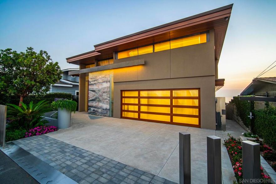 A rare opportunity to own Encinitas’ most significant new construction oceanfront estate. Located on the prized bluff at 1230 Neptune Avenue, this modern coastal masterpiece spans 7,089 sqft and offers private beach access, an amenity almost unheard of in today’s regulatory climate. Secured under a 2008 Coastal Dev Permit, it is the final oceanfront home of its kind permitted in California, making it truly irreplaceable. Every detail of this 4-bedroom, 7-bathroom residence has been designed for elevated coastal living, with glass walls that frame panoramic ocean views and a commercial-grade elevator connecting all levels. Amenities rivaling those found in Del Mar, La Jolla, or Malibu include a state-of-the-art theater, lounge bar, teak wine cellar, gym, spa, sauna, and bluffside Jacuzzi. The retractable beach staircase leads to one of the most coveted stretches of sand in North County. Unsurpassed in quality and privacy, this architectural tour de force would command nearly double or more in other premier coastal markets. Encinitas is a vibrant coastal town and destination for those seeking a healthy, outdoor lifestyle offering elite beaches, surfing, and hiking alongside a thriving arts and culture scene immersed in a kaleidoscopic habitat, renowned as the "Flower Capital of the World". Just minutes from Carlsbad Airport, this San Diego oceanfront gem delivers an unmatched combination of privacy, innovation, and refined coastal elegance. From its legal entitlements to its breathtaking execution, 1230 Neptune Ave is not just a home, it’s a legacy built to last.