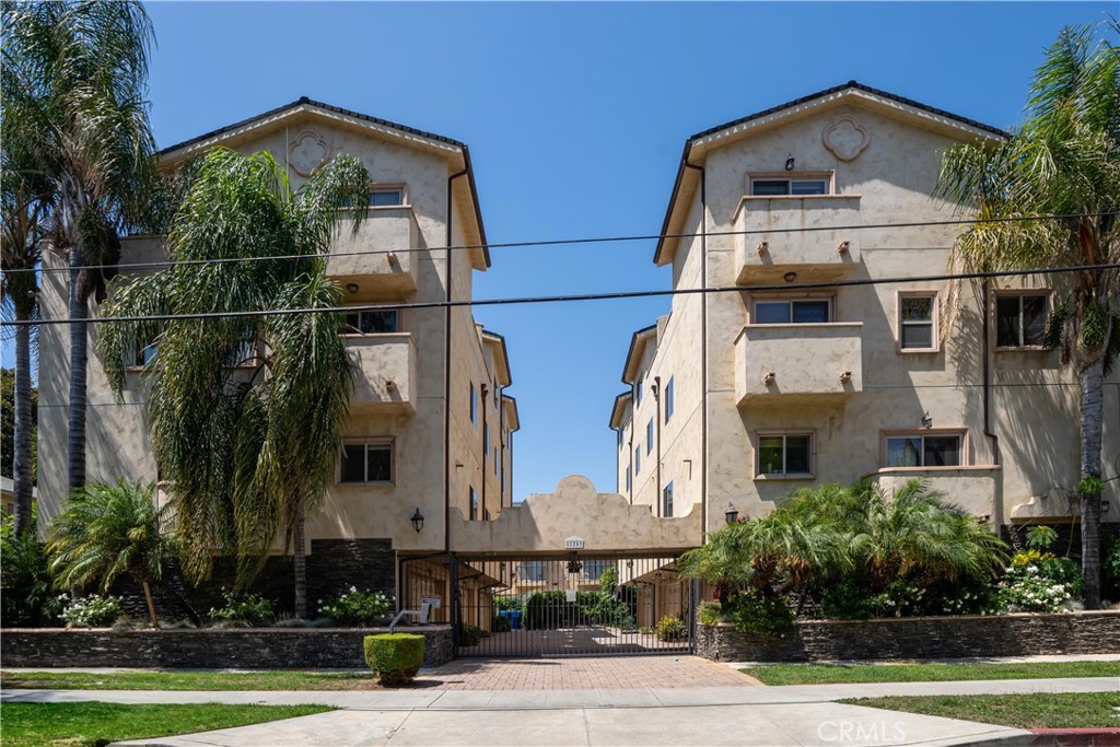 This beautifully designed front-unit condominium offers the space and layout of a townhome, along with a prime location near the border of NoHo and West Toluca Lake. With 4 bedrooms and 3.5 baths across approximately 1,760 sq ft, this multi-level home features an attached 2-car garage located beneath the main entry level, providing direct access into the unit. Inside, a spacious, light-filled living area welcomes you with arched architectural details and a sleek modern fireplace, blending warmth with clean design. The contemporary kitchen features stainless steel appliances, complemented by coordinating brown-toned granite countertops and backsplash that adds warmth and visual continuity. Two of the bedrooms are primary suites—one offering a separate shower, soaking tub, double sink vanity, and a generously sized closet with built-in shelving and drawers. A beautiful blend of dark engineered wood and light stone flooring runs throughout the home. Multiple balconies and a private rooftop terrace offer inviting outdoor spaces to relax or entertain. The secured building includes a gated entry and access to the parking area, with direct entry into a private, attached 2-car garage—a rare convenience in condominium living. Part of a boutique 6-unit complex with low HOA dues of $340/month, the home is conveniently located near the NoHo Arts District, Toluca Lake Village, NoHo West, Chandler Bike Path, and major studios like Universal and Warner Bros, with easy access to the North Hollywood Metro Station and freeways including the 170, 134, and 101. Blending comfort, style, and convenience in a vibrant and well-connected neighborhood, this is the kind of space you’ll love coming home to.