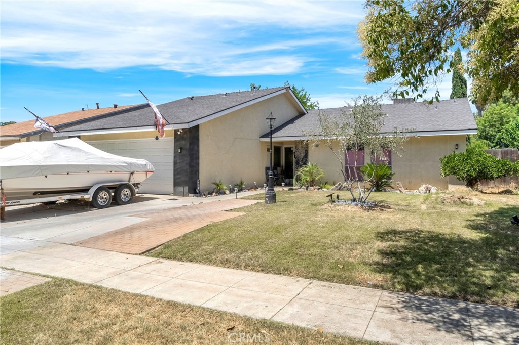 Step inside this beautiful 4-bedroom, 2-bath home in Fresno and be greeted by an airy, open layout filled with natural light. The spacious living room features tall ceilings, expansive windows, and a striking black fireplace that adds a modern touch of character. The heart of the home is the open-concept kitchen, fully upgraded with a huge center island, gas stove, updated cabinetry, and plenty of storageperfect for both everyday living and entertaining. The seamless flow from the kitchen to the living and dining areas makes this space as functional as it is inviting. Down the hall, you'll find cozy carpeted bedrooms, including a generously sized primary suite with not one, but two closets and direct access to the backyard through elegant double doors. Both bathrooms have been updated, and there's ample storage throughout the home to keep things organized and clutter-free. Step outside to enjoy the 6,000 sq ft lot featuring a covered patio and a nicely maintained yard. With 1,581 sq ft of smartly designed living space, this home combines modern updates, thoughtful layout, and a welcoming atmosphere ready for you to move in and make it yours.