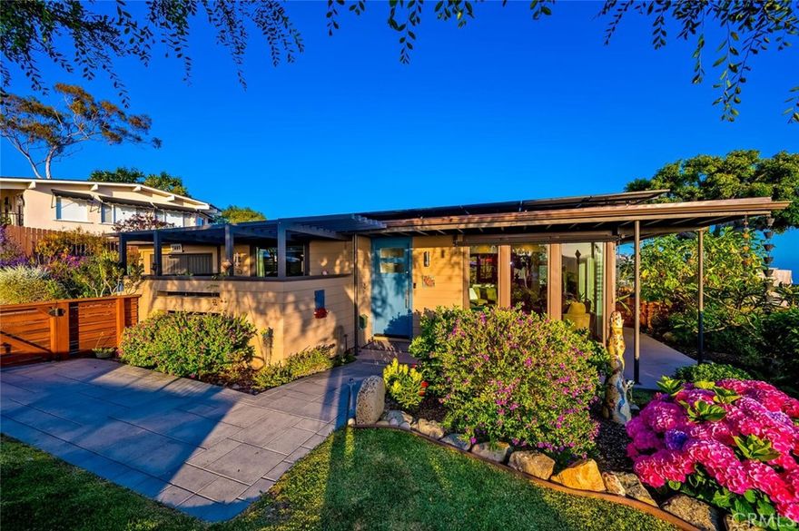 Perched above the pristine coves of laguna beach, this mid century modern masterpiece echoes the timeless influence of early Frank Loyd Wright design. With iconic post-and-beam construction and dramatic walls of glass, the home is thoughtfully positioned to capture sweeping ocean and canyon vistas from every angle. This single level, two bedroom two bath retreat has been beautifully remodeled to blend classic architecture with modern comforts. New floor to ceiling windows and elevated skylights flood the space with natural light, while lush landscaping and panoramic views create a seamless indoor outdoor living experience. Set on nearly 10,000 square feet of flat, useable land, the home offers privacy, serenity, and room to grow-complete with architectural plans included in the sale and potential for an ADU. Inside, a chef's ocean view kitchen flows effortlessly into the open plan living and dining rooms, grounded by rich wood flooring, and elegant stone surfaces throughout. Step outside onto the expansive wrap around deck, where a gentle breeze and post card worthy sunsets await. Cozy up by the wood burning fireplace as day turns into night and the coastline begins to glow. Whether you're seeking a peaceful retreat, an entertainer's dream, or a foundation for future expansion, this one of a kind architectural jewel delivers it all.