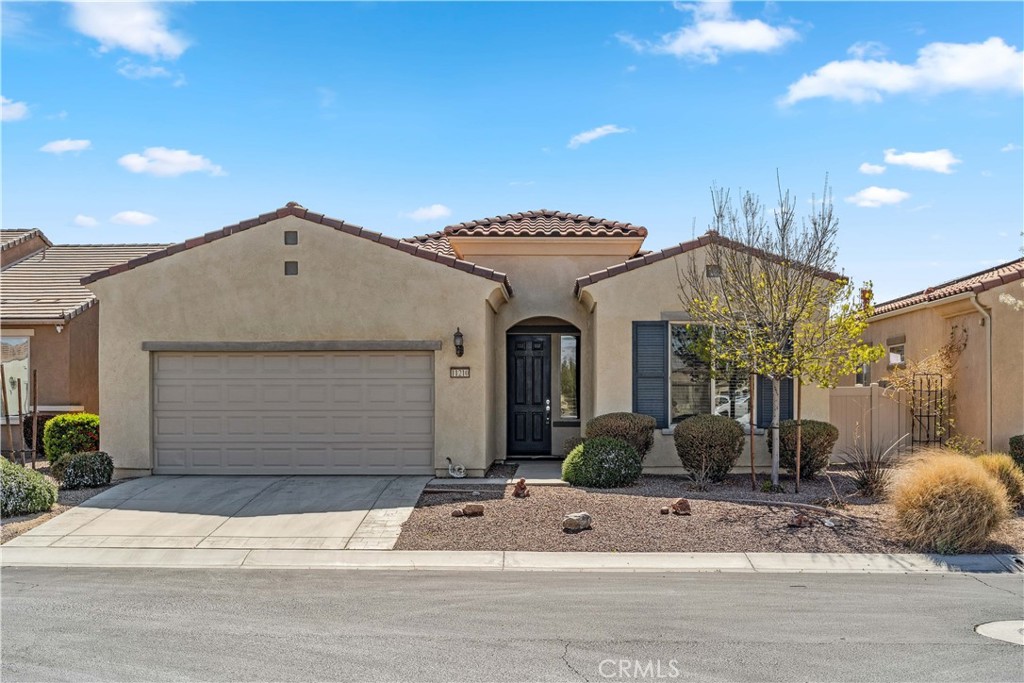 This beautifully updated 1,915 sq. ft. home offers 2 bedrooms, 2 bathrooms, a versatile den/office, an indoor laundry room, and a spacious 2-car garage with extra storage space. Step into the open-concept living area where the modern kitchen shines with granite countertops, a large center island, pantry, and seamless flow into the dining area and great room – perfect for entertaining or relaxing in style. Enjoy 10-foot ceilings and luxury vinyl flooring throughout that gives the home a bright, inviting feel. The primary suite is a retreat of its own, featuring a large walk-in closet, dual vanities, a soaking tub, and a separate shower. The second bedroom and full bath offer comfort and privacy for guests, while the den is ideal for a home office, hobby room, or extra lounge space. Step outside to your private backyard oasis with breathtaking mountain views and serene natural surroundings, located next to a peaceful riverbed – the perfect spot for morning coffee or evening sunsets. This vibrant community features a golf course, indoor and outdoor pools, a gym, hot tub, and an active clubhouse with a calendar full of planned social events and activities. Don’t miss this opportunity to live in one of Apple Valley’s premier 55+ communities.