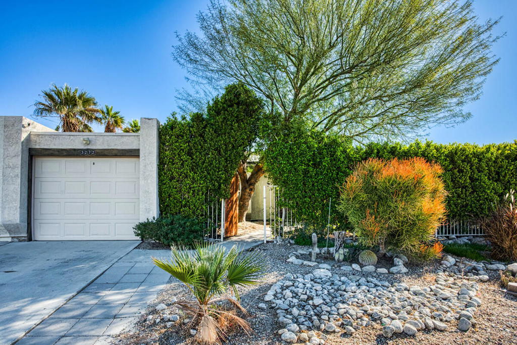 Welcome to this beautifully updated 2-bedroom, 1-bath pool home, offering the perfect blend of comfort, style, and smart living. Set behind a lush privacy hedge, the gated front yard and manicured landscaping create a warm, welcoming curb appeal.Inside, enjoy vaulted ceilings, recessed lighting, tile floors, and modern Smart Home features including a smart thermostat and keyless entry. The light-filled living room flows into the dining area and kitchen, complete with wood cabinetry, a tile backsplash, and stainless steel appliances. Sliding doors lead to both a private side patio and the backyard, enhancing the indoor-outdoor lifestyle.Both bedrooms are spacious, and the remodeled bathroom features a dual-sink vanity and a large walk-in shower. The private backyard is a true retreat, with an in-ground pool and spa controlled by a newly installed Pentair smart system (heater with ScreenLogic remote).With fully owned solar panels, an attached 2-car garage, no HOA fees, and close proximity to shopping and dining, this move-in ready home also offers excellent vacation rental potential. Don't miss your chance to own this Palm Springs gem!