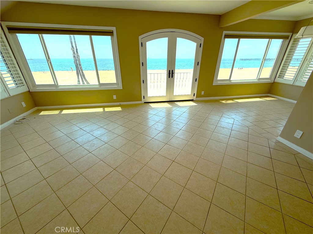 This beautifully remodeled upstairs oceanfront unit offers breathtaking, year-round panoramic views of the Pacific. Open the elegant French doors to invite in the soothing ocean breeze and take in stunning sunrises and sunsets from the comfort of your home. Thoughtfully updated throughout, the unit features stylish laminate flooring, classic window shutters, a modernized bathroom, and a separate dining area that exudes understated elegance. Recent upgrades include a new heater, recessed lighting, ceiling fans, and fresh paint, creating a bright and tranquil atmosphere. The kitchen comes fully equipped with a stove, new refrigerator, dishwasher, and microwave. Additional conveniences include a community laundry room and covered parking, completing this serene coastal retreat.